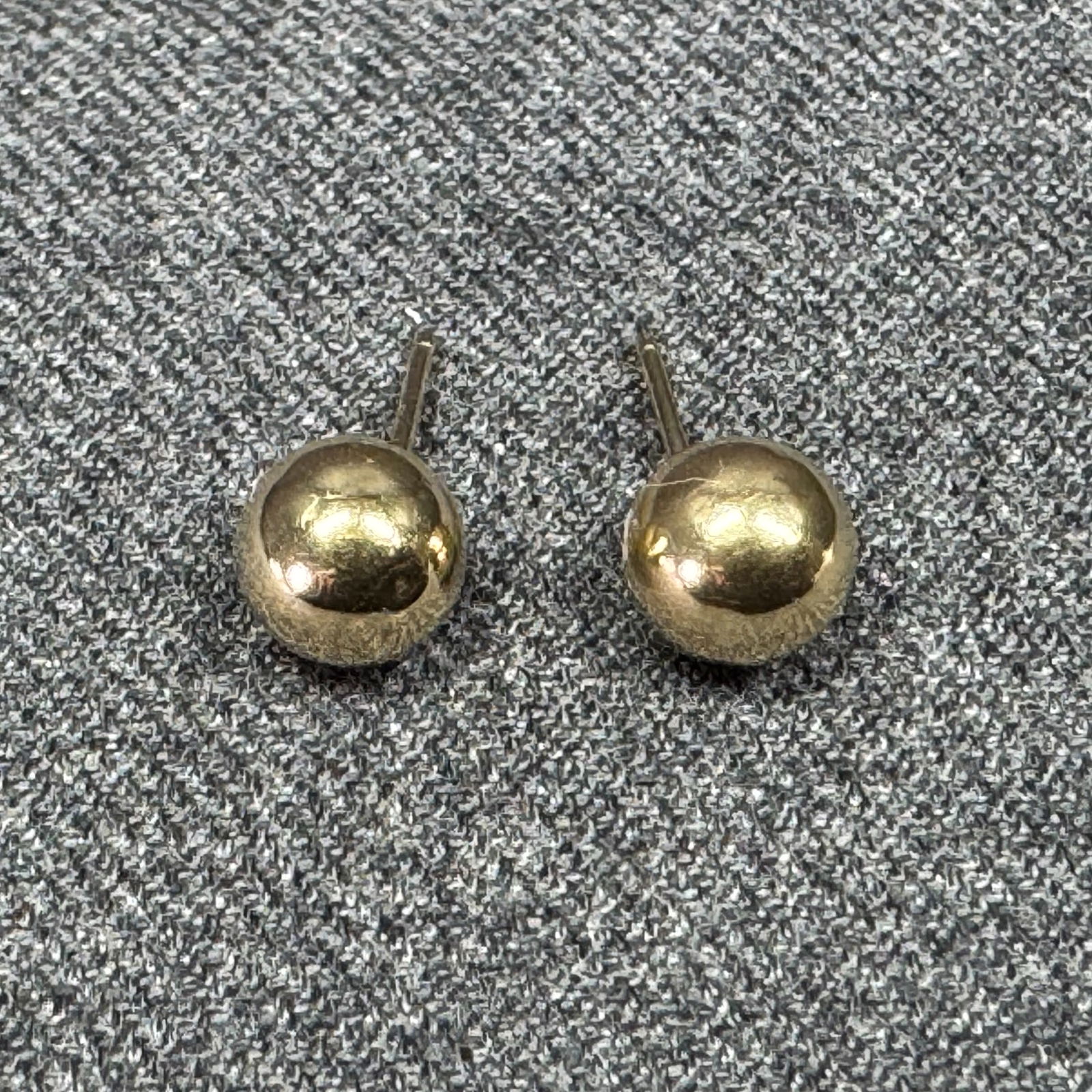 14K yellow gold ball stud earrings. Marked: 14K yellow gold ball stud earrings. Marked 14K and unreadable mark and PAT. For measures please refer to the pictures taken with a measuring tape. Weight: 0.34 grams. IN HOUSE Estimated* shipping and