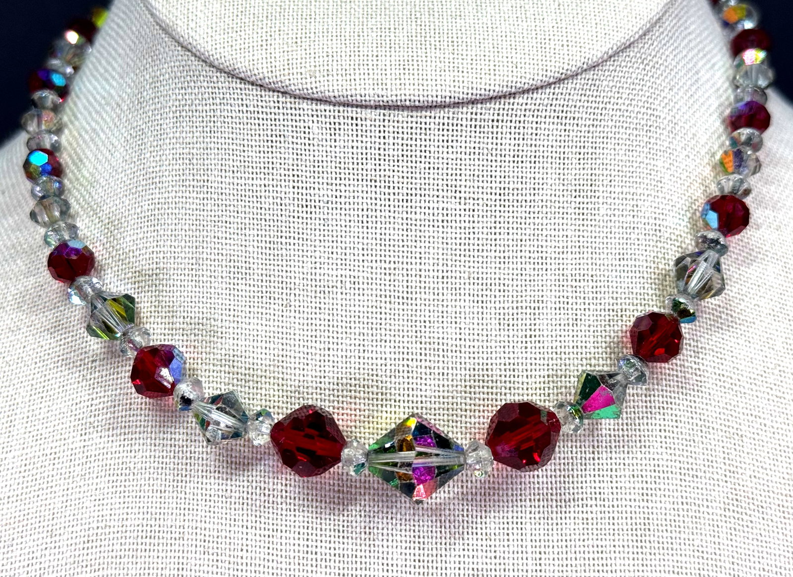 Vintage faceted AB and ruby color crystals collar necklace: Vintage faceted AB and ruby color crystals collar necklace. Unmarked. For measures please refer to the pictures taken with a measuring tape. Weight: 20 Grams. IN HOUSE Estimated* shipping and handling
