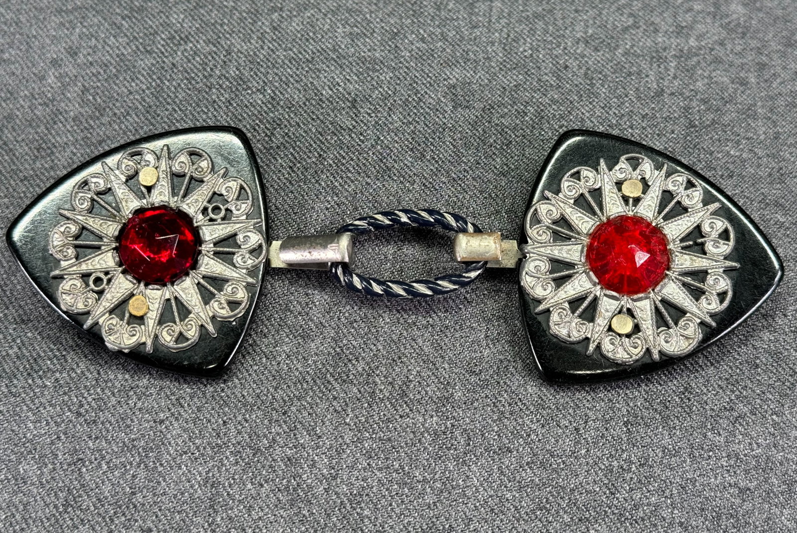 Antique art deco faceted red glass cab filigree silvertone metal black galalith belt buckle: Antique art deco faceted red glass cab filigree silvertone metal black galalith belt buckle. Unmarked. For measures please refer to the pictures taken with a measuring tape. Weight: 30 Grams. This is 