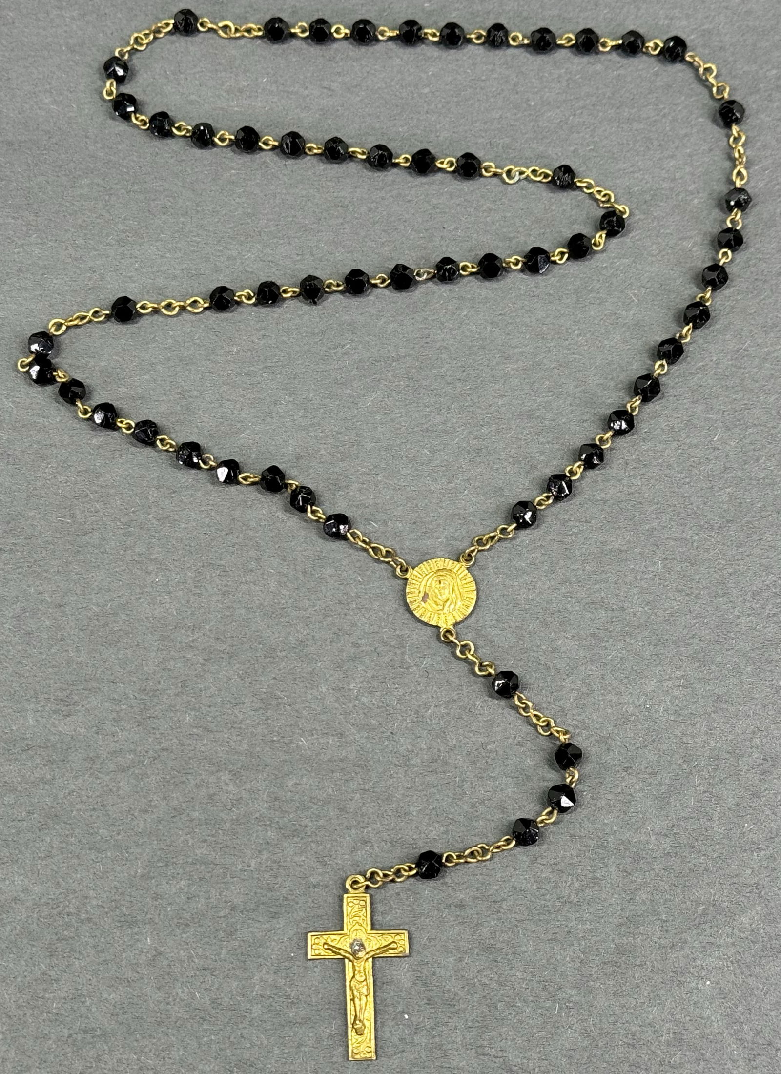 Vintage Czech Crucifix Our Lady & Our Sacred Heart medal faceted black glass mourning rosary: Vintage Czech mourning goldtone metal Crucifix Our Lady & Our Sacred Heart medal faceted black glass rosary. Marked Czechoslovakia. Original patina. For measures please refer to the pictures taken wit