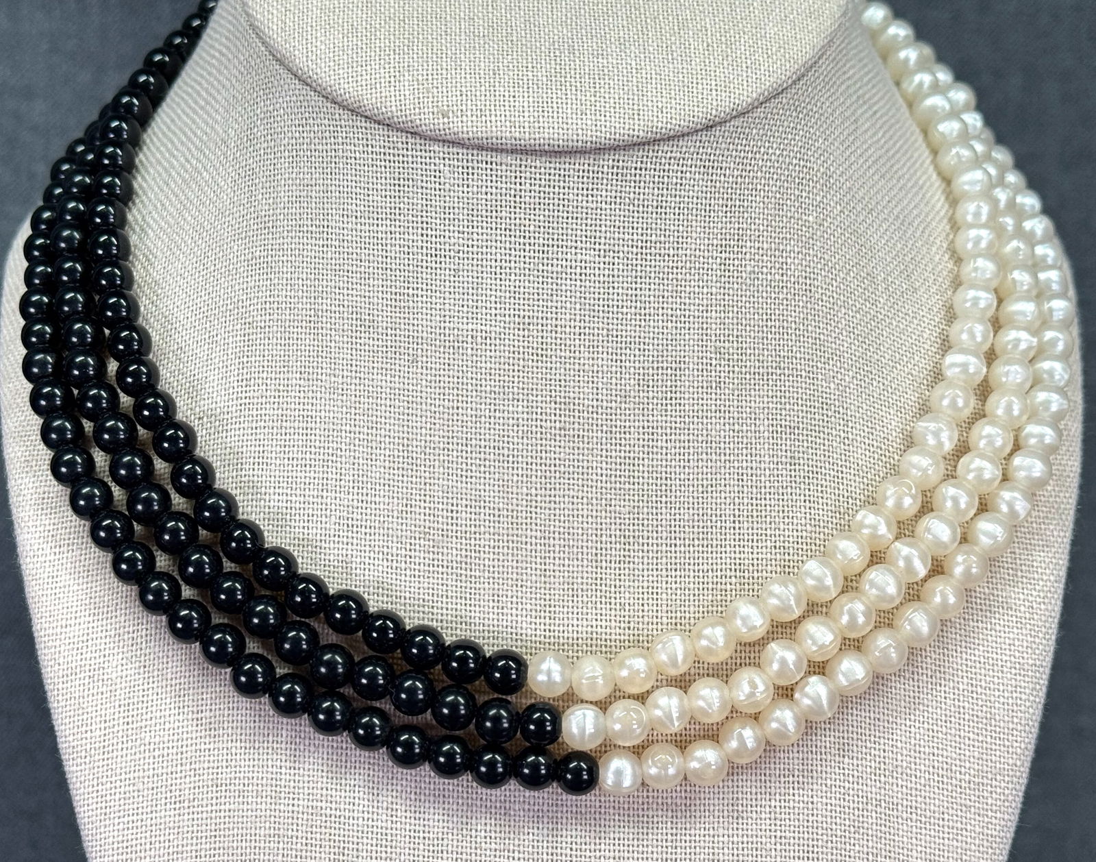 Vintage 90s Monet black & pearly plastic three strands necklace: Vintage 90s Monet black & pearly plastic three strands necklace. Marked. For measures please refer to the pictures taken with a measuring tape. Weight: 30 Grams. IN HOUSE Estimated* shipping and handl