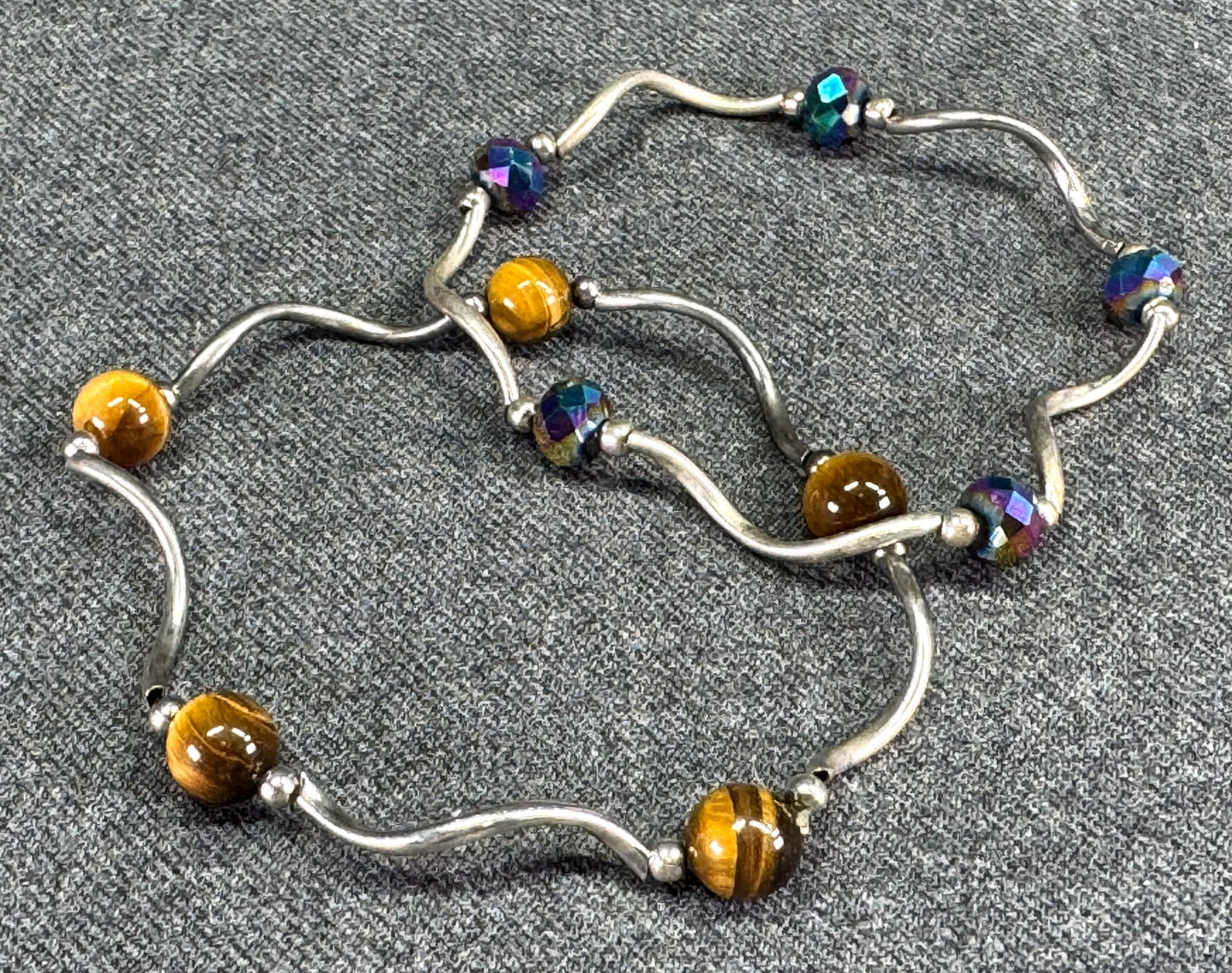 Vintage modernist style tiger eye stone & faceted ab crystals silver metal beads elastic bracelets.: Vintage modernist style assorted tiger eye stone and faceted ab crystals silver metal beads elastic bracelets. Unmarked. For measures please refer to the pictures taken with a measuring tape. Weight: 