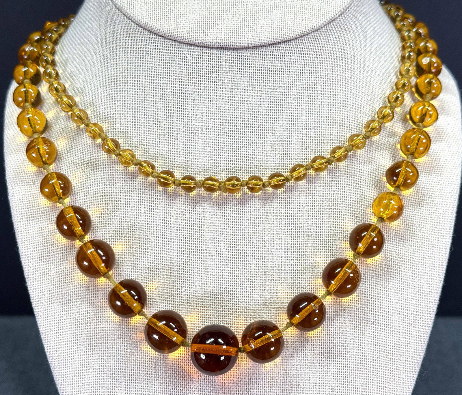 Vintage Antique art deco flapper graduated amber color glass beads necklace.: Vintage Antique art deco flapper graduated amber color glass beads necklace. Hand knotted in between Unmarked. For measures please refer to the pictures taken with a measuring tape. Weight: 54 grams.