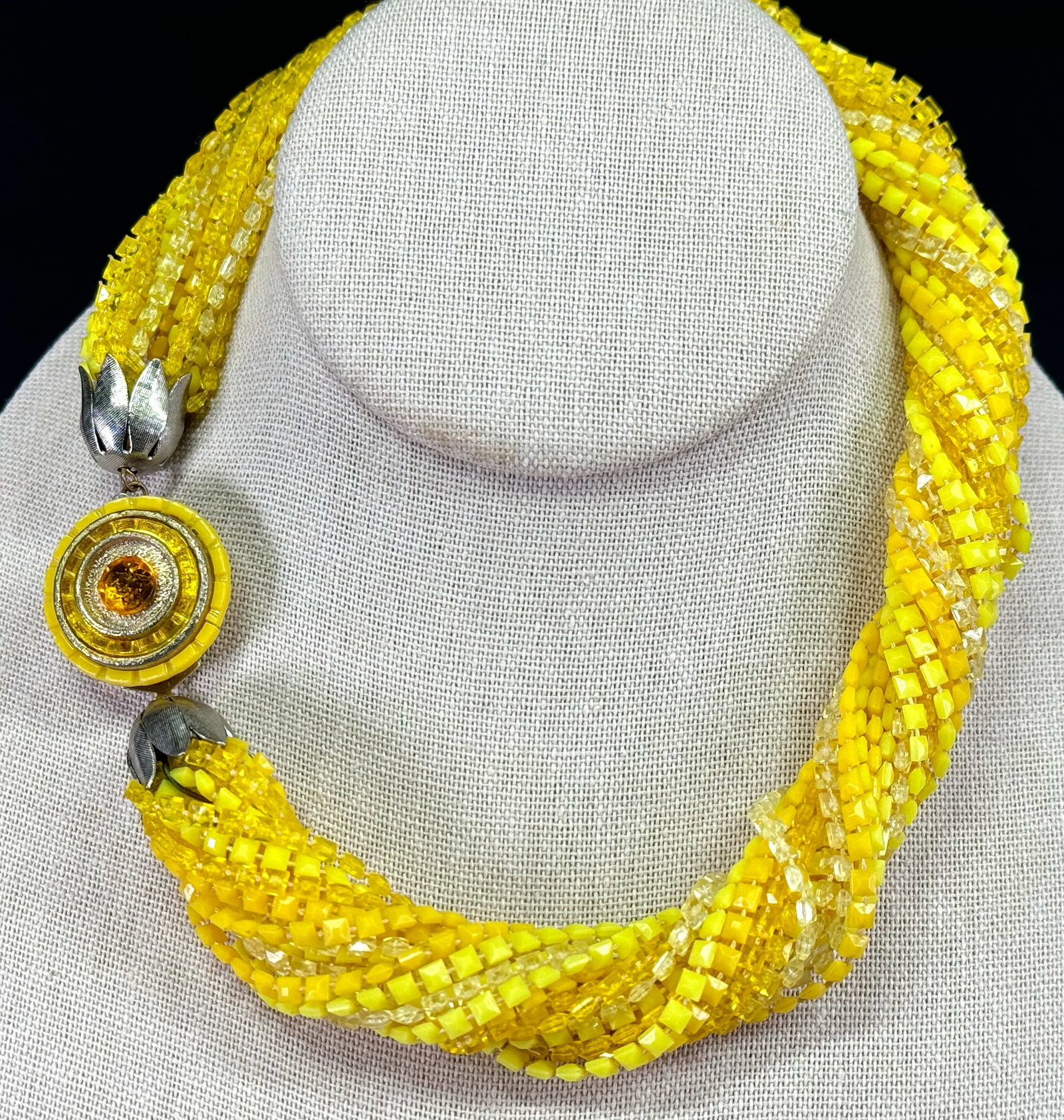Vintage jeweled flower goldtone metal clasp multi strand yellowish thermoplastic beaded necklace.: Vintage jeweled flower goldtone metal clasp multi strand yellowish thermoplastic beaded necklace. Unmarked. For measures please refer to the pictures taken with a measuring tape. Weight: 48 Grams. Thi