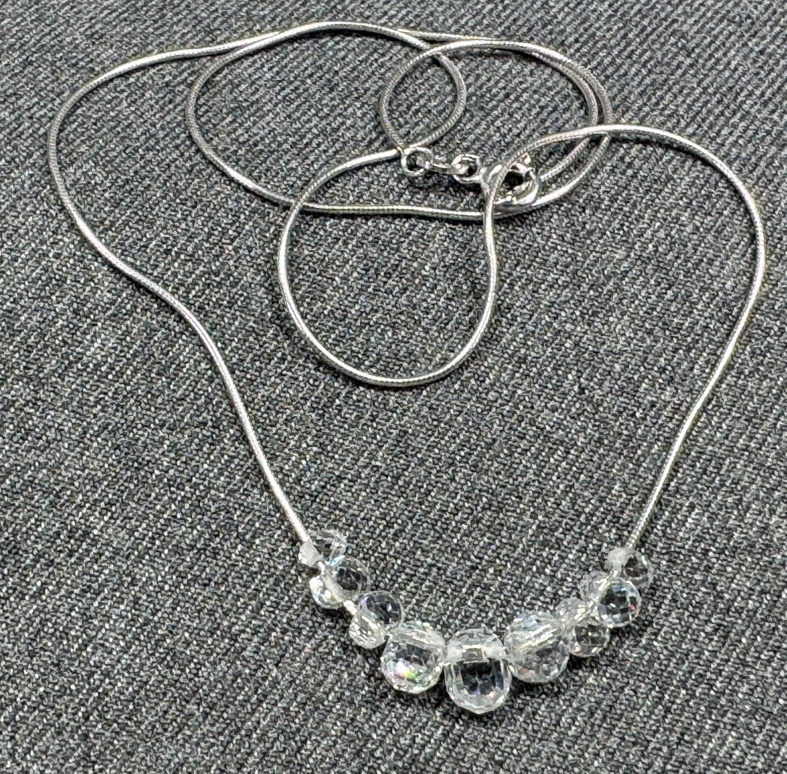 Italian graduated faceted cubic zirconia sliding beads snake sterling silver chain: Italian graduated faceted cubic zirconia sliding beads snake sterling silver chain. Marked Italy 925 DQ CZ. For measures please refer to the pictures taken with a measuring tape. Weight: 5.40 grams IN
