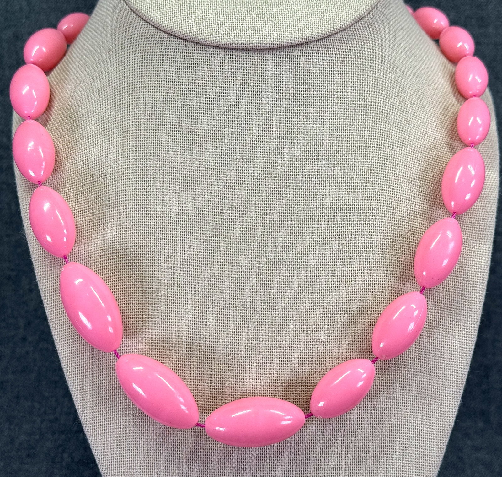 Vintage pink thermoplastic graduated beads necklace: Vintage pink thermoplastic graduated beads necklace. Unmarked. For measures please refer to the pictures taken with a measuring tape. Weight: 38 Grams. IN HOUSE Estimated* shipping and handling cost w