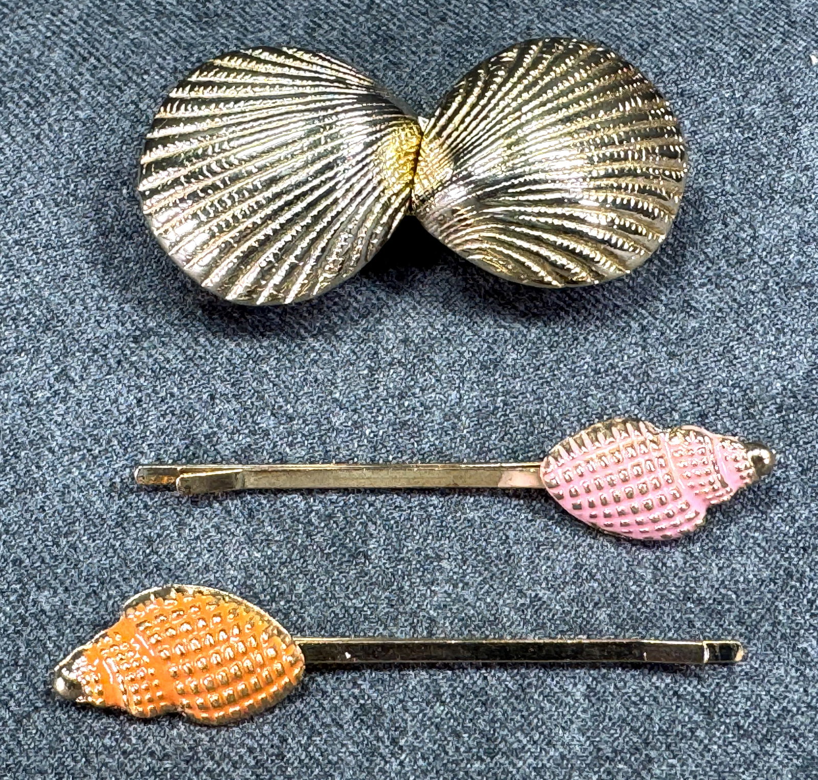 Vintage goldtone shell shaped belt buckle and enamel hair clips: Vintage goldtone shell shaped belt buckle and enamel hair clips. Unmarked. For measures please refer to the pictures taken with a measuring tape. Weight:45 Grams. IN HOUSE Estimated* shipping and hand