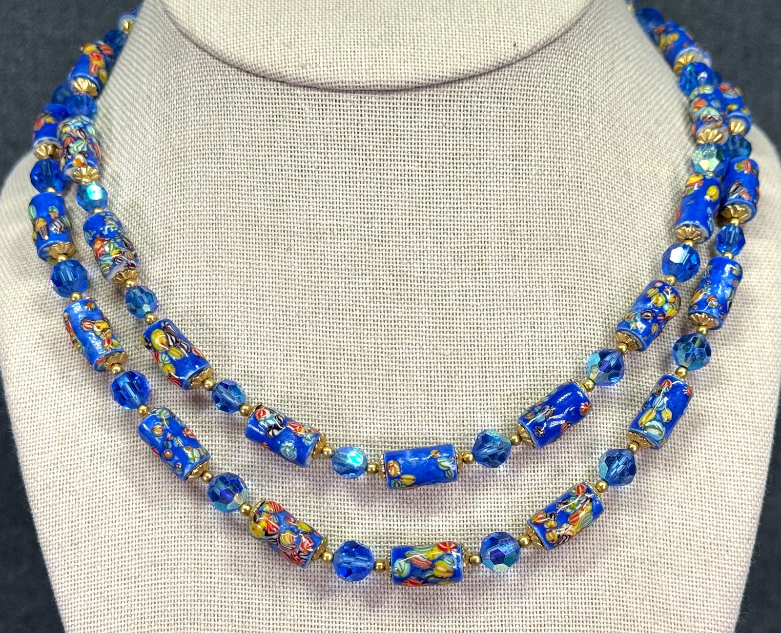 Vintage enamel murrina pottery and AB blue crystals, golden metal beaded necklace. Filigree clasp: Vintage enamel murrina pottery and AB blue crystals, golden metal beaded necklace. Filigree clasp. Unmarked. For measures please refer to the pictures taken with a measuring tape. Weight: 50 Grams. IN