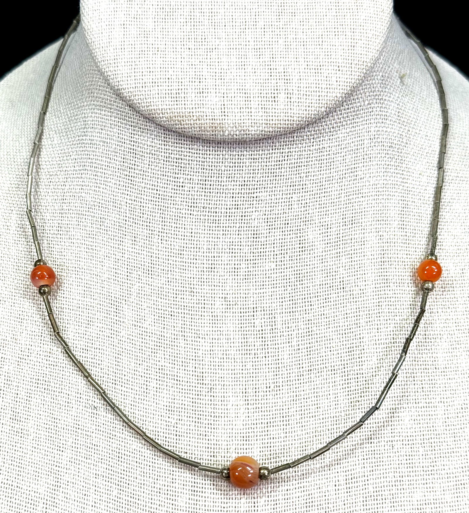 Vintage native american orange agate stone and liquid silver beaded choker necklace.: Vintage native american orange agate stone and liquid silver beaded choker necklace. Unmarked. For measures please refer to the pictures taken with a measuring tape. It measures around 16 inches long.