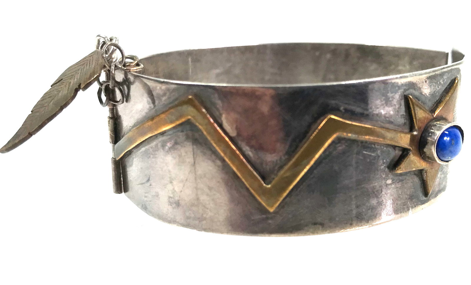 Native American lapis bronze shooting stars sterling bracelet: Vintage native american bronze shooting stars one of them with a lapis cab sterling silver hinged small bracelet. Pin clasp with feather dangle. Unidentified pictorial mark. It measures 5 5/8 inches i