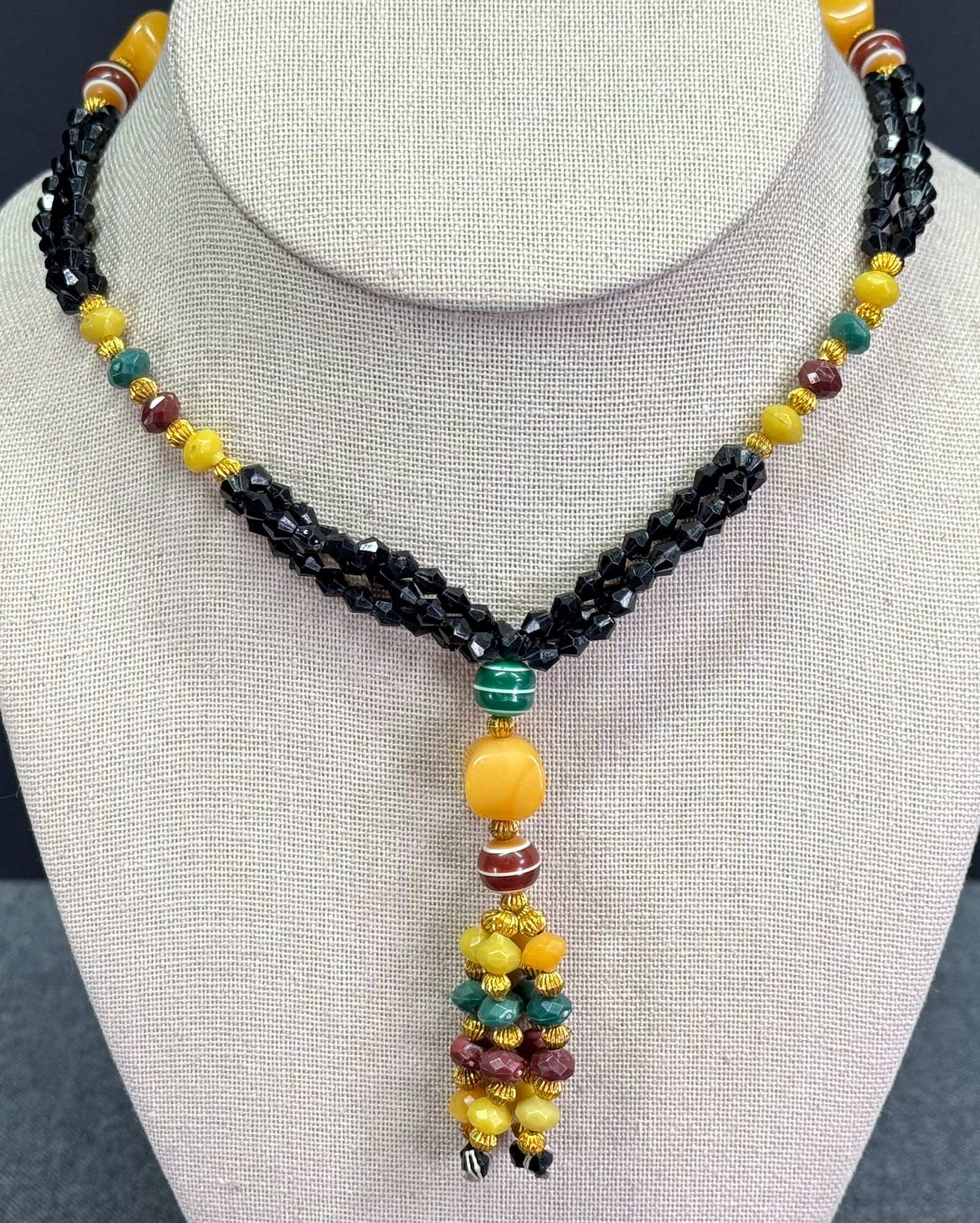 Vintage ethnic style color plastic beaded necklace with tassel: Vintage ethnic style color plastic beaded necklace with tassel. Unmarked. For measures please refer to the pictures taken with a measuring tape. Weight: 23 Grams. This is a NO RESERVE AUCTION: there a