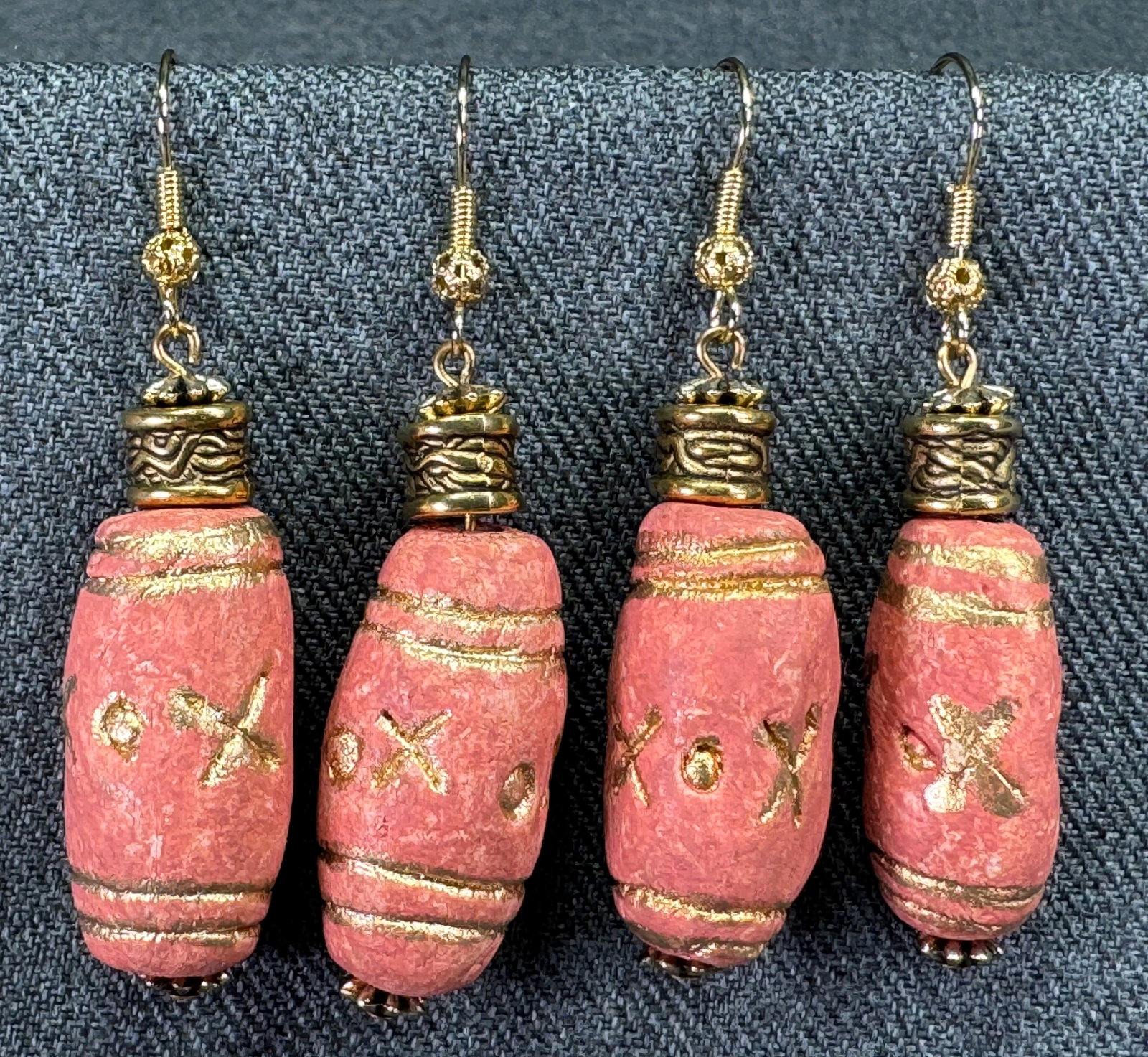Vintage ethnic style golden accents coral color pottery hook earrings. Unused. Lot of 2: Vintage ethnic style golden accents coral color pottery hook earrings. Unused. Lot of 2. Unmarked. For measures please refer to the pictures taken with a measuring tape. Weight: 30 Grams. This is a NO