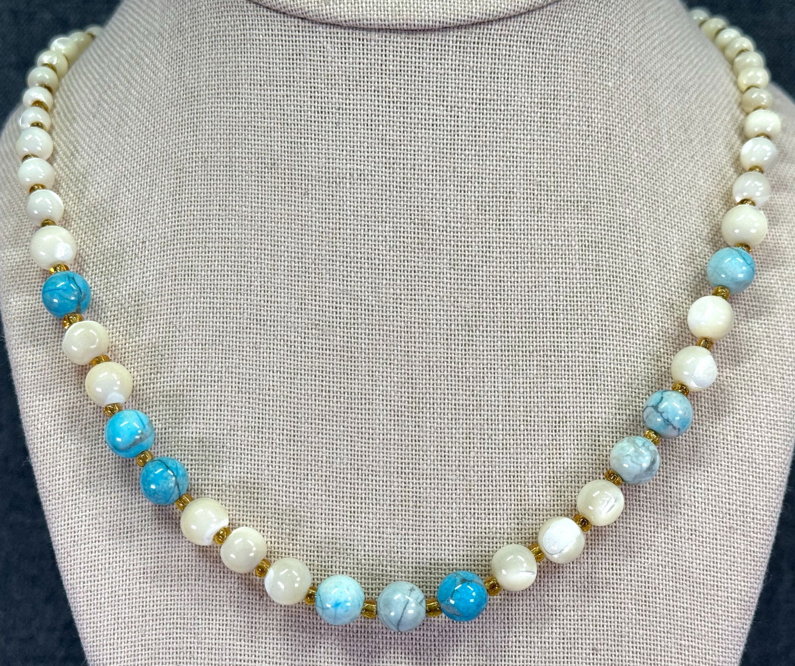 Vintage mother of pearl MOP, reconstituted turquoise & glass beaded necklace: Vintage mother of pearl MOP, reconstituted turquoise & glass beaded necklace. Unmarked. For measures please refer to the pictures taken with a measuring tape. Weight: 29 Grams. IN HOUSE Estimated* shi