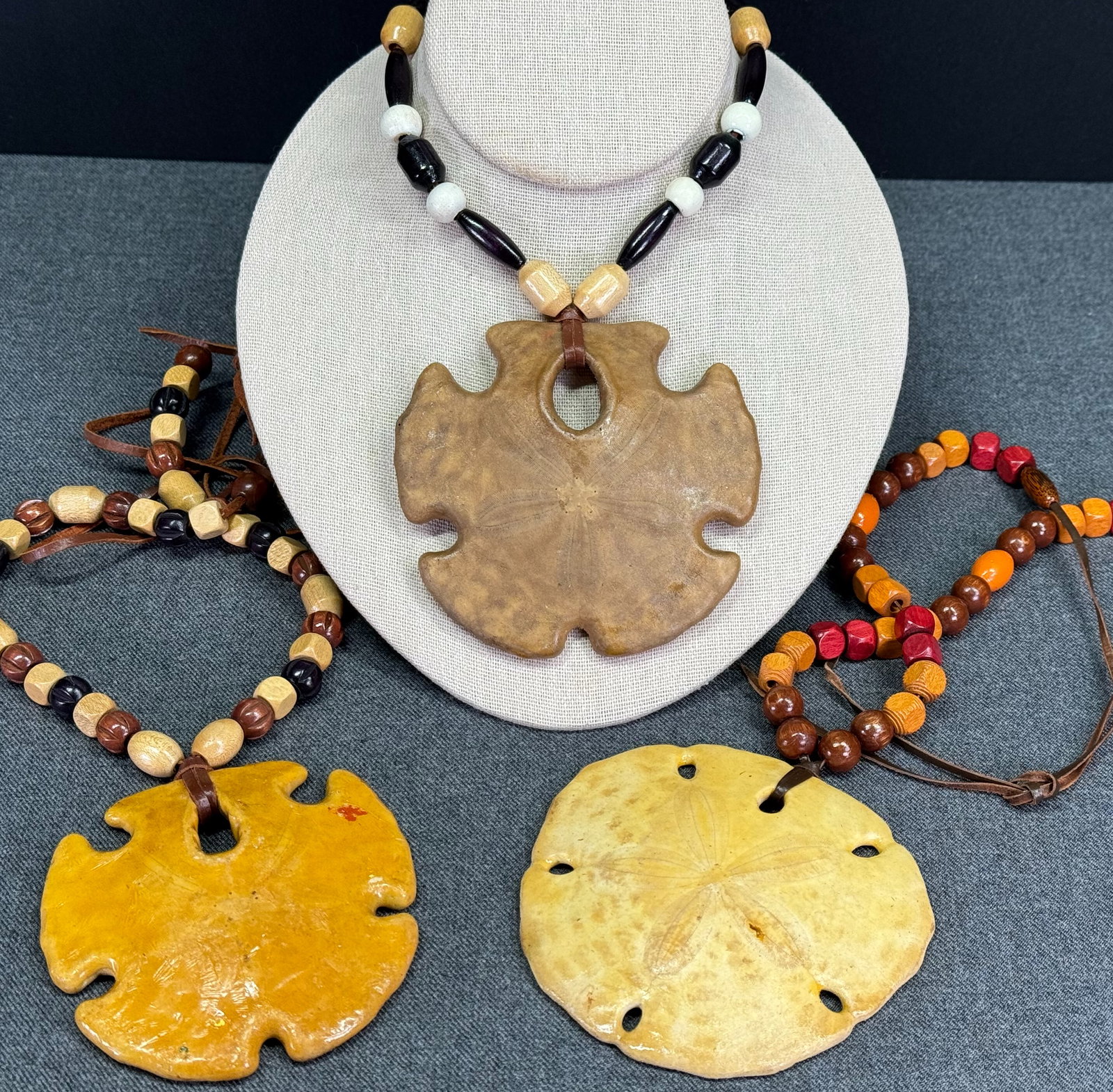 Cover-Up Creations Arizona sand dollar wooden beads leather strap necklace. Lot of 3: Cover-Up Creations Arizona sand dollar wooden beads leather strap necklace. Unmarked. The paper and the label in the last 2 pictures are not included. For measures please refer to the pictures taken w