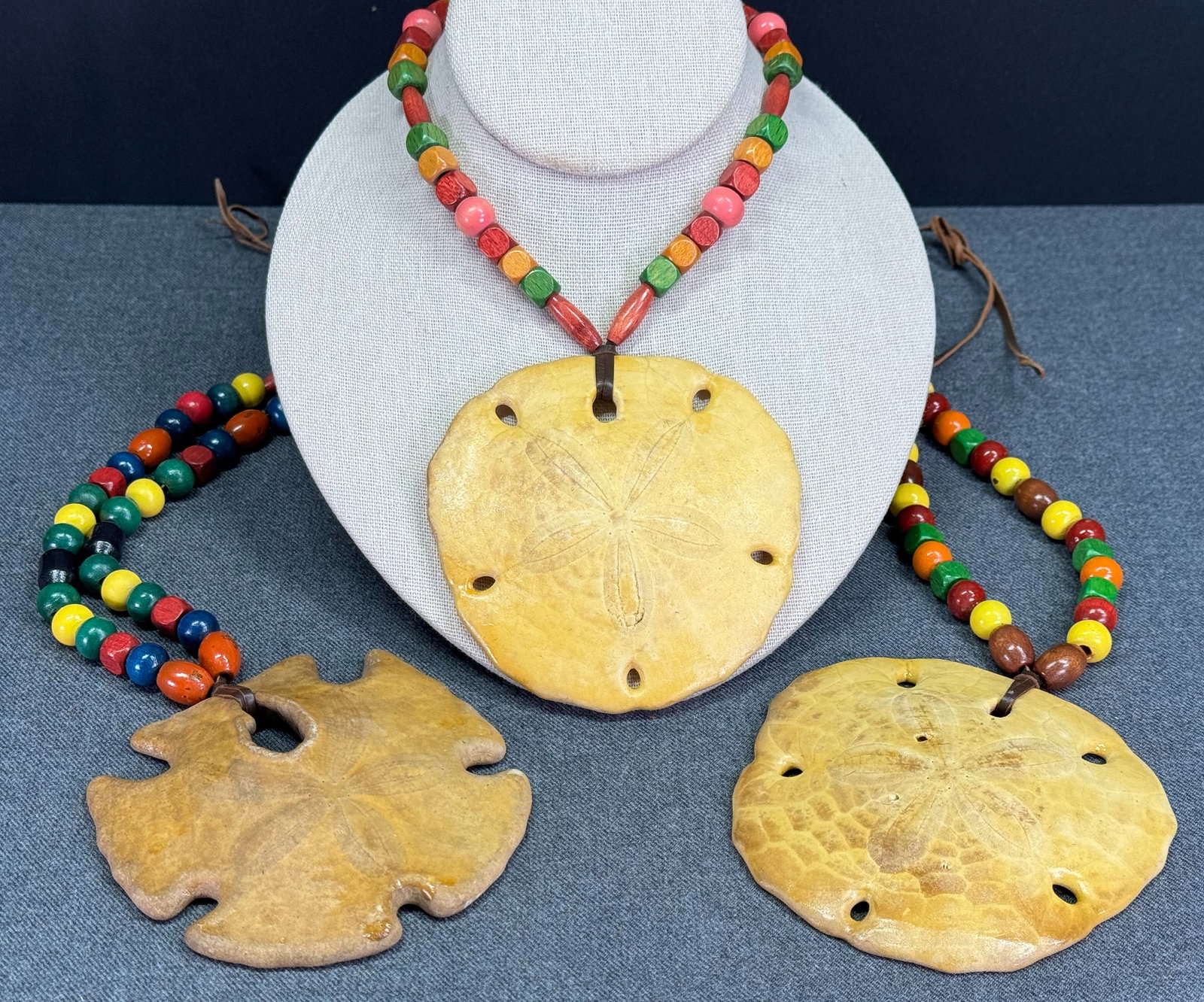Cover-Up Creations Arizona sand dollar wooden beads leather strap necklace. Lot of 3: Cover-Up Creations Arizona sand dollar wooden beads leather strap necklace. Unmarked. The paper and the label in the last 2 pictures are not included. For measures please refer to the pictures taken w