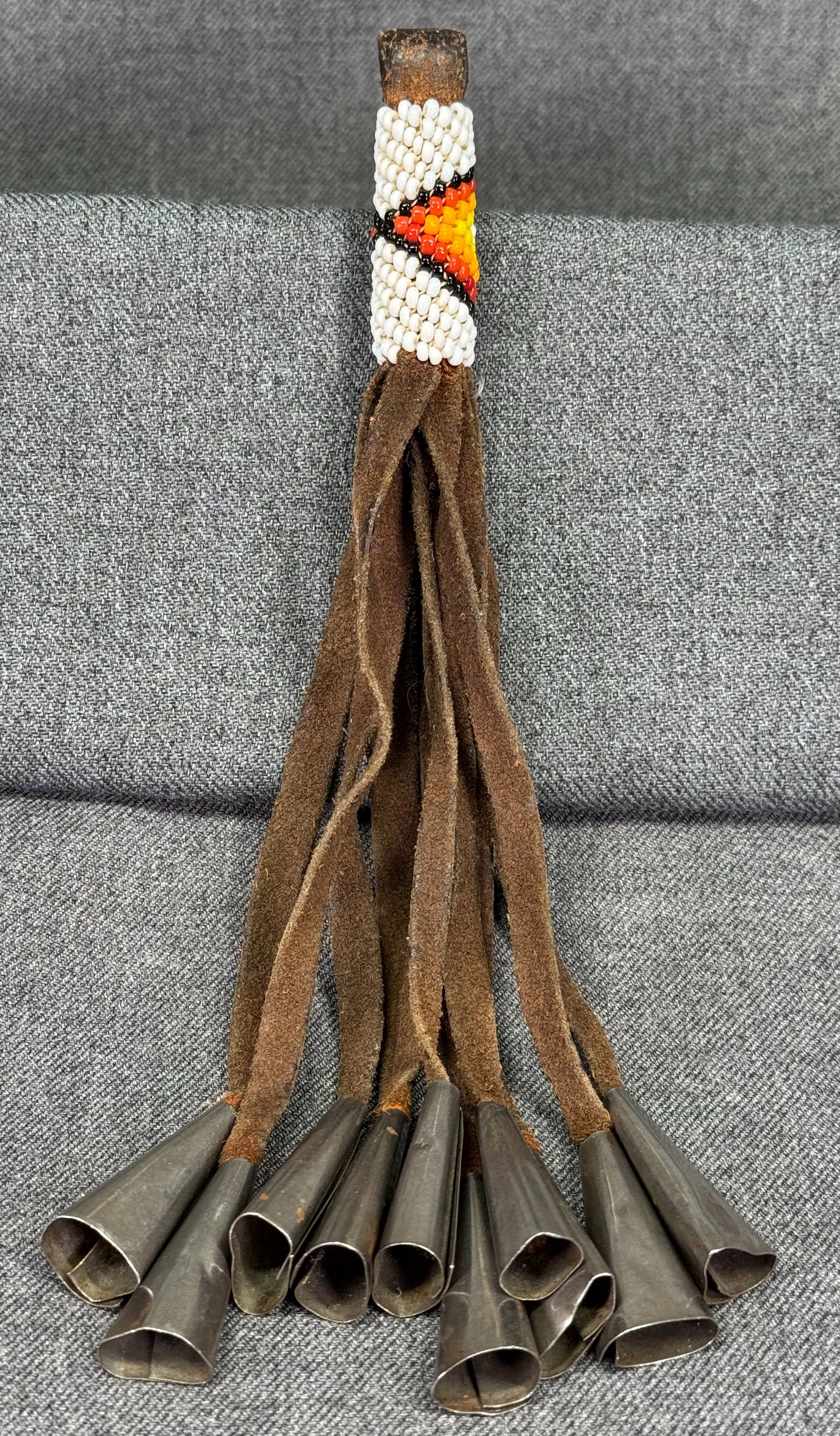 Vintage native American style glass beaded & leather tassel pendant with metal dangles: Vintage native American style glass beaded & leather tassel pendant with metal dangles. Unmarked . For measures please refer to the pictures taken with a measuring tape. Weight: 30 Grams. IN HOUSE Est
