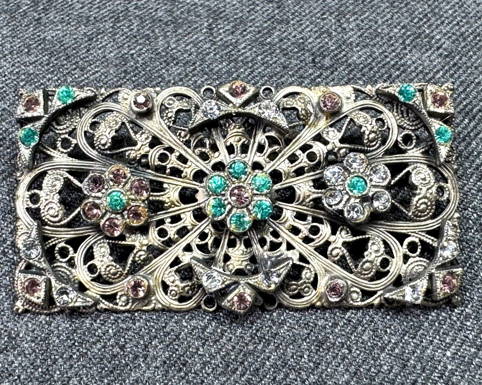 Antique Czech color crystals filigree silvertone flowers brooch pin: Antique Czech color crystals filigree silvertone flowers brooch pin. Unmarked. For measures please refer to the pictures taken with a measuring tape. Weight: 12 Grams. IN HOUSE Estimated* SHIPPING & H