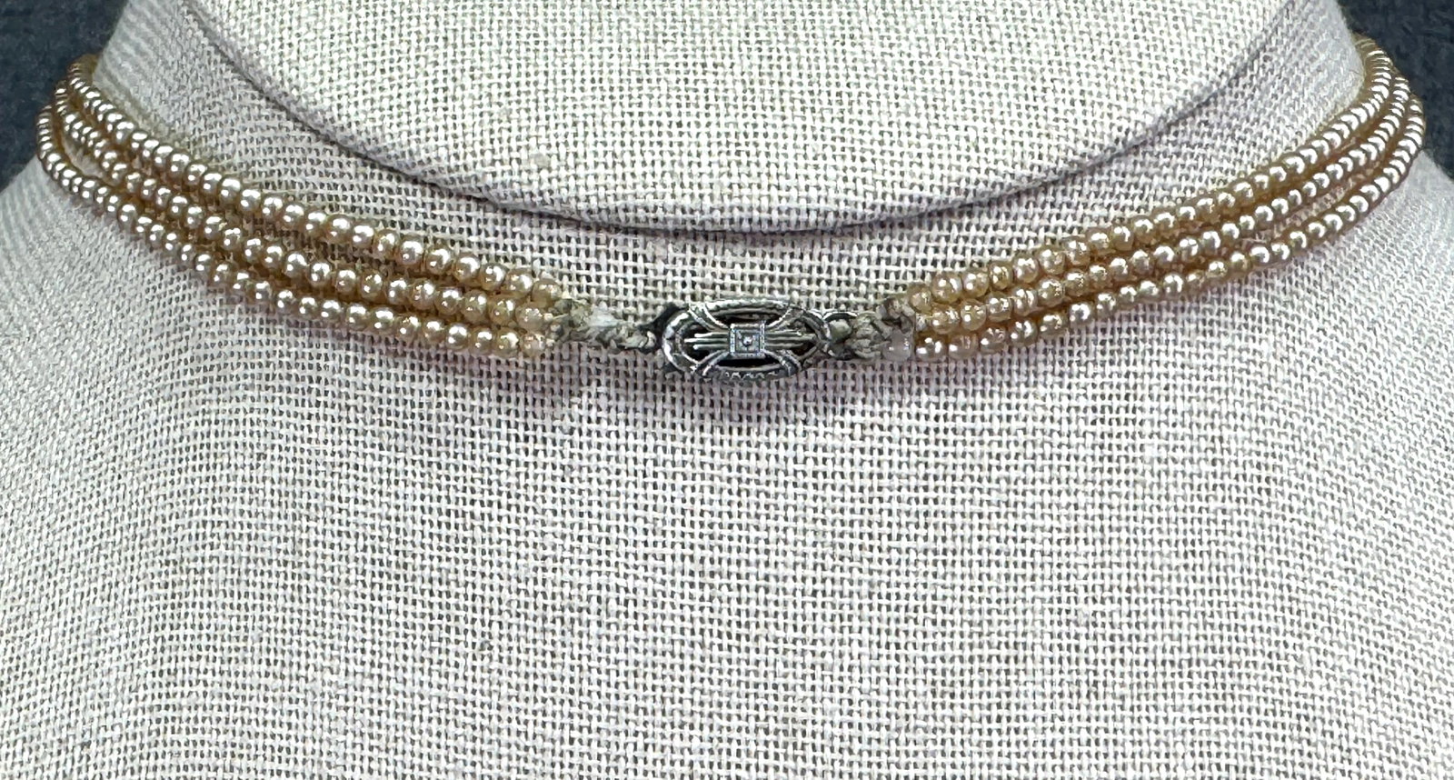 Vintage tiny pearly beads filigree sterling clasp 3 strands collar necklace: Vintage tiny pearly beads filigree sterling clasp 3 strands collar necklace. Marked. For measures please refer to the pictures taken with a measuring tape. Weight: 9 Grams. IN HOUSE Estimated* shippin