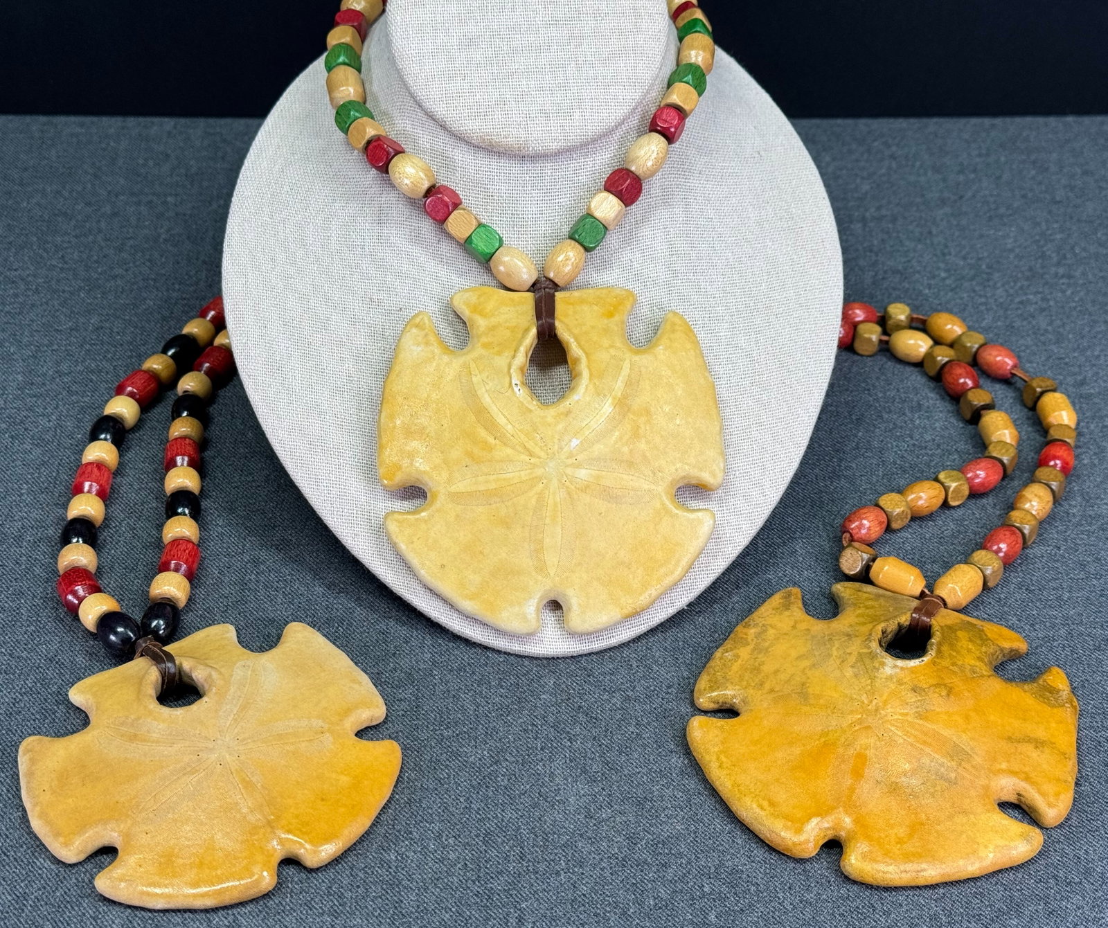 Cover-Up Creations Arizona sand dollar wooden beads leather strap necklace. Lot of 3: Cover-Up Creations Arizona sand dollar wooden beads leather strap necklace. Unmarked. The paper and the label in the last 2 pictures are not included. For measures please refer to the pictures taken w