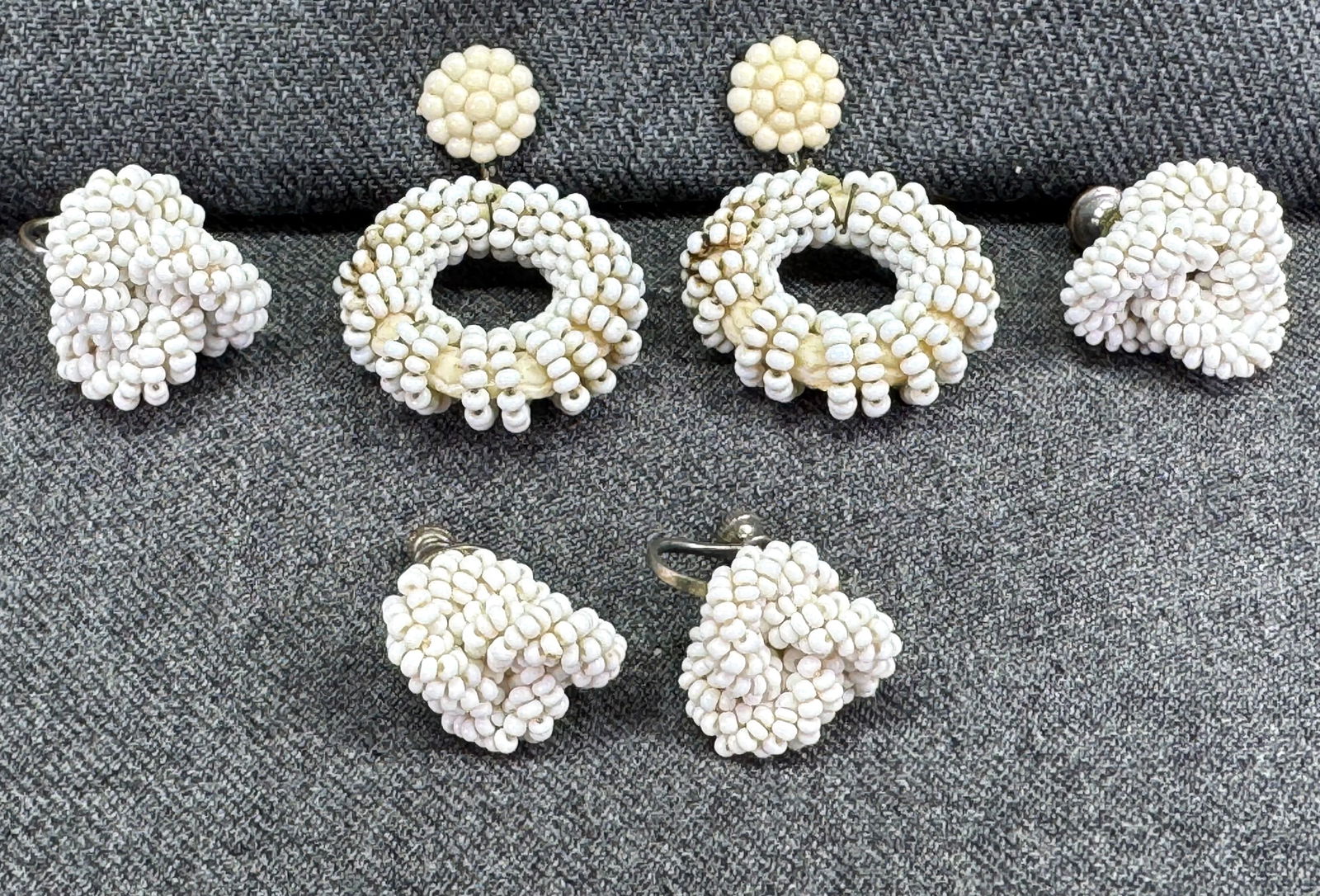 Vintage two woven white seed glass beads & dangle donut plastic flower top screw back earrings: Vintage two woven white seed glass beads & dangle donut plastic flower top screw back earrings. Unmarked. For measures please refer to the pictures taken with a measuring tape. Weight: 20 Grams This i