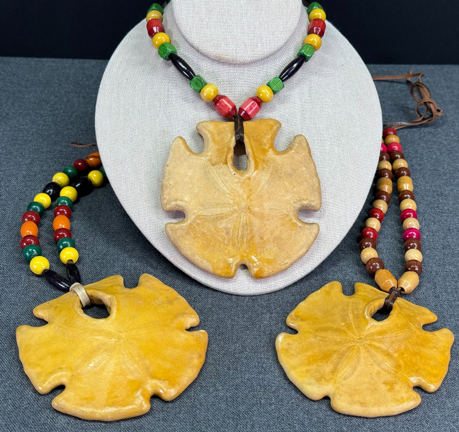 Cover-Up Creations Arizona sand dollar wooden beads leather strap necklace. Lot of 3: Cover-Up Creations Arizona sand dollar wooden beads leather strap necklace. Unmarked. The paper and the label in the last 2 pictures are not included. For measures please refer to the pictures taken w