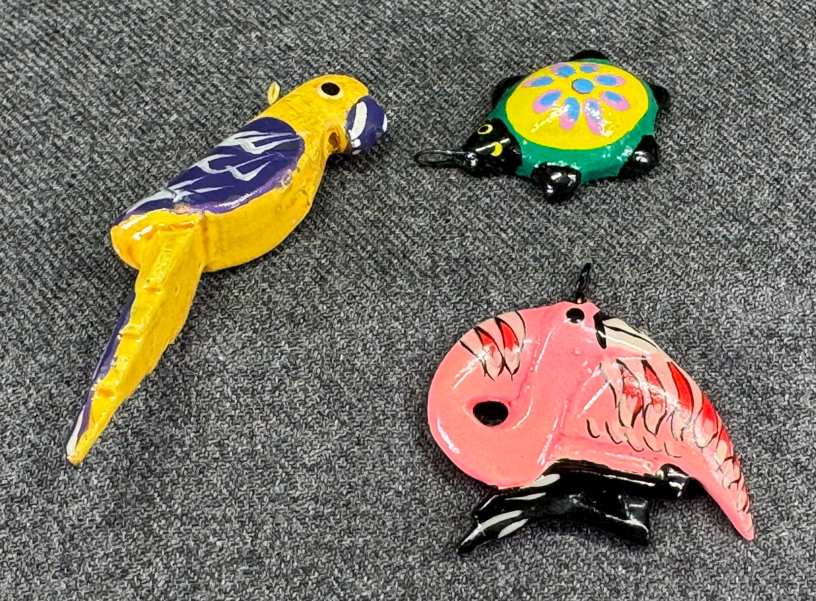 Vintage folk art hand painted wooden flamingo, turtle, parrot pendants: Vintage folk art hand painted wooden flamingo, turtle, parrot pendants. Unmarked. For measures please refer to the pictures taken with a measuring tape. Weight: 6 Grams. IN HOUSE Estimated* shipping a