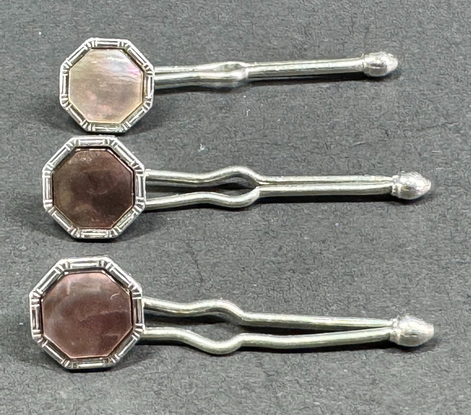 Vintage Heraldic gray MOP silvertone metal studs. Lot of 3. Marked.: Vintage Heraldic gray MOP silvertone metal studs. Lot of 3. Marked. Frankfurth Hdw Co Milwaukee label . For measures please refer to the pictures taken with a measuring tape. Weight: 3 Grams . This is
