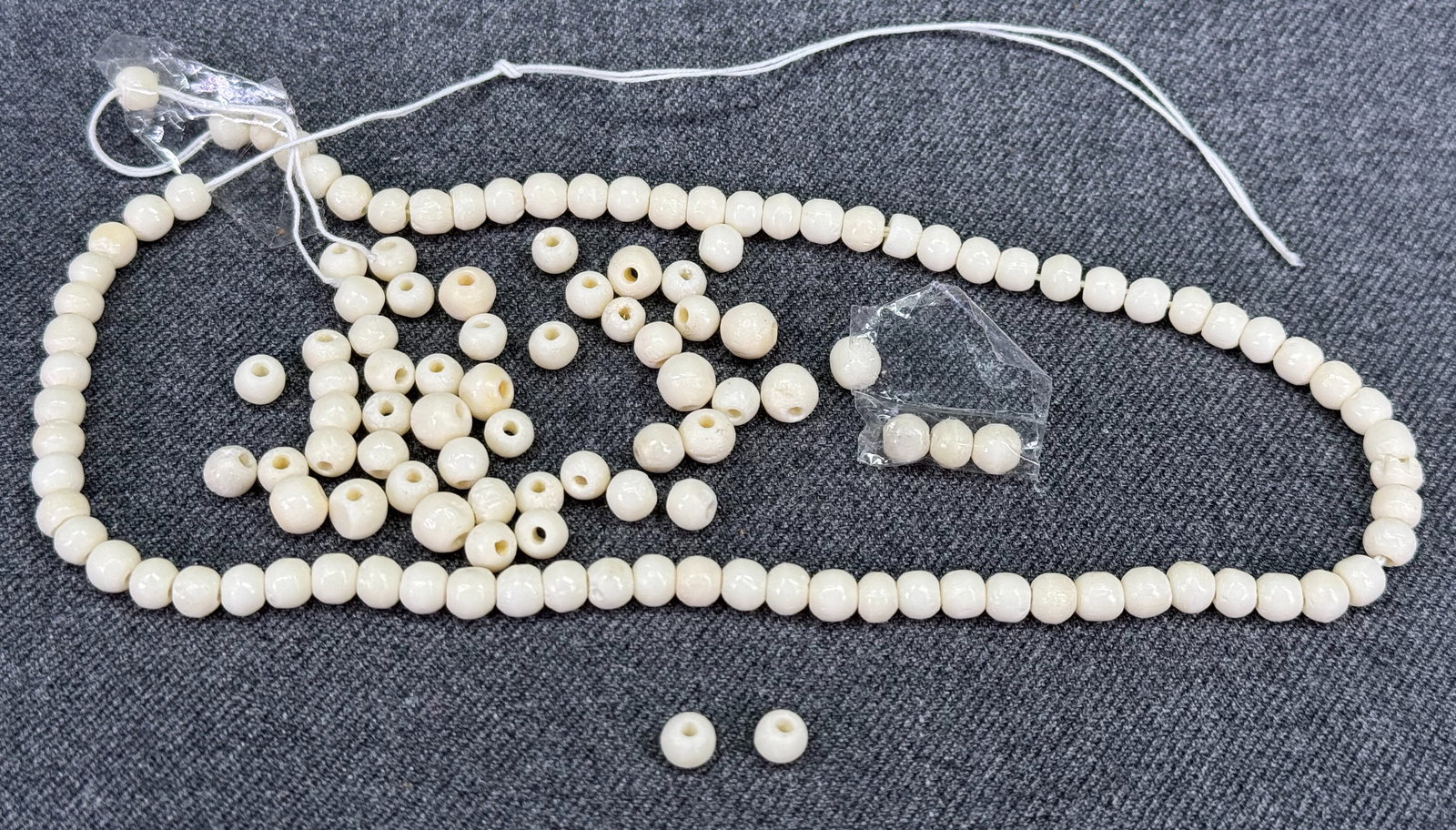 Vintage assorted rounded bone beads.: Vintage assorted rounded bone beads.String around 12 1/2 inches long + loose beads. Unmarked. For measures please refer to the pictures taken with a measuring tape. Weight:25 Grams. IN HOUSE Estimated