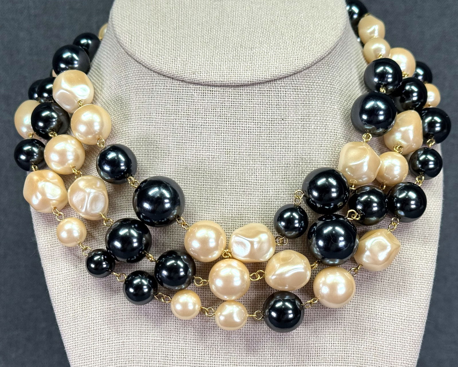 Vintage Monet creamy & dark gray pearly beads bib necklace: Vintage Monet creamy & dark gray pearly beads wired goldtoned metal 3 strands bib necklace. Marked. For measures please refer to the pictures taken with a measuring tape. Weight: 125 Grams. IN HOUSE E