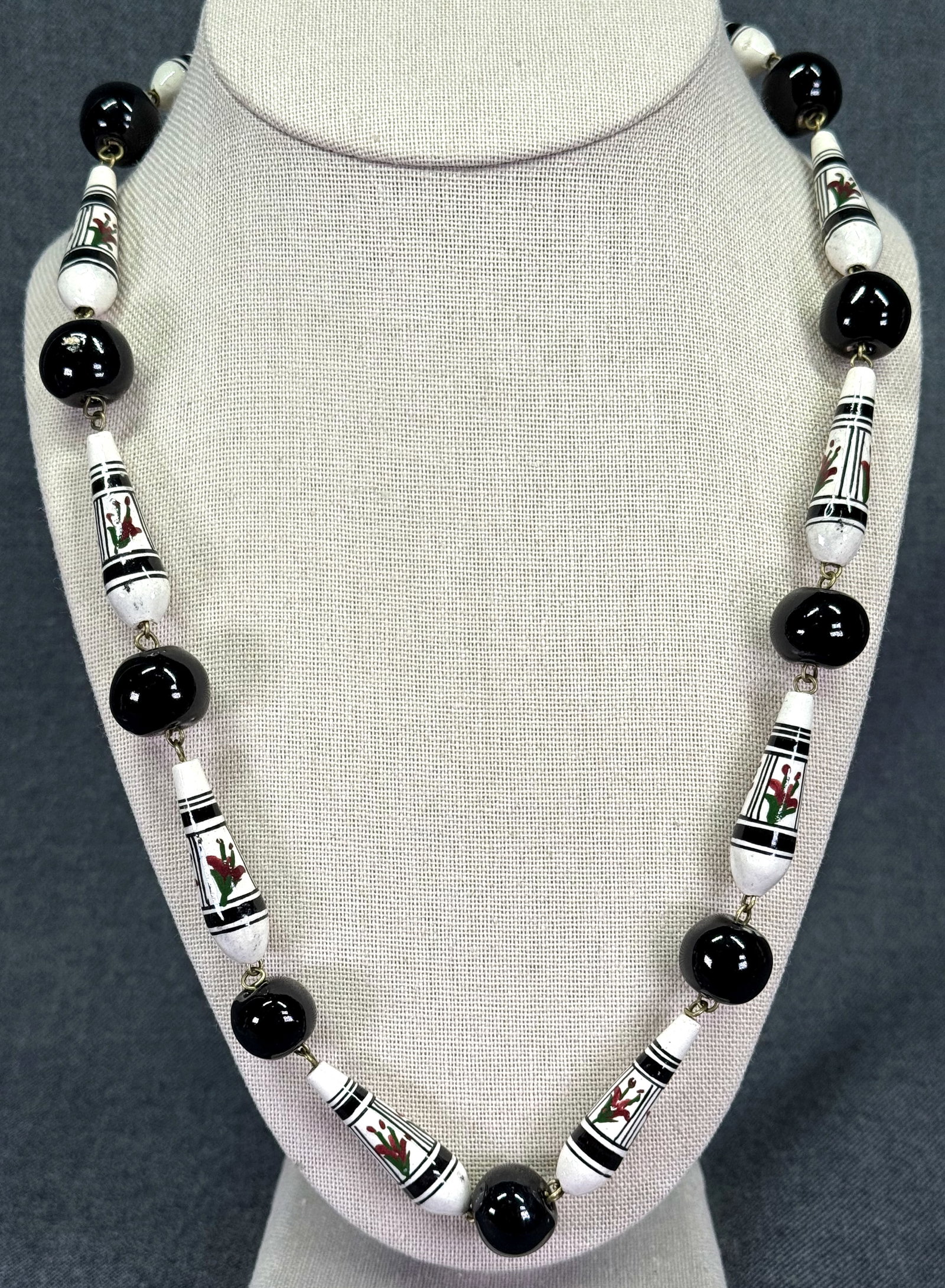 Vintage folk ethnic hand painted flowers & black pottery wired beads necklace: Vintage folk ethnic hand painted flowers & black pottery wired beads necklace. Unmarked. For measures please refer to the pictures taken with a measuring tape. Weight: 56 Grams. IN HOUSE Estimated* SH