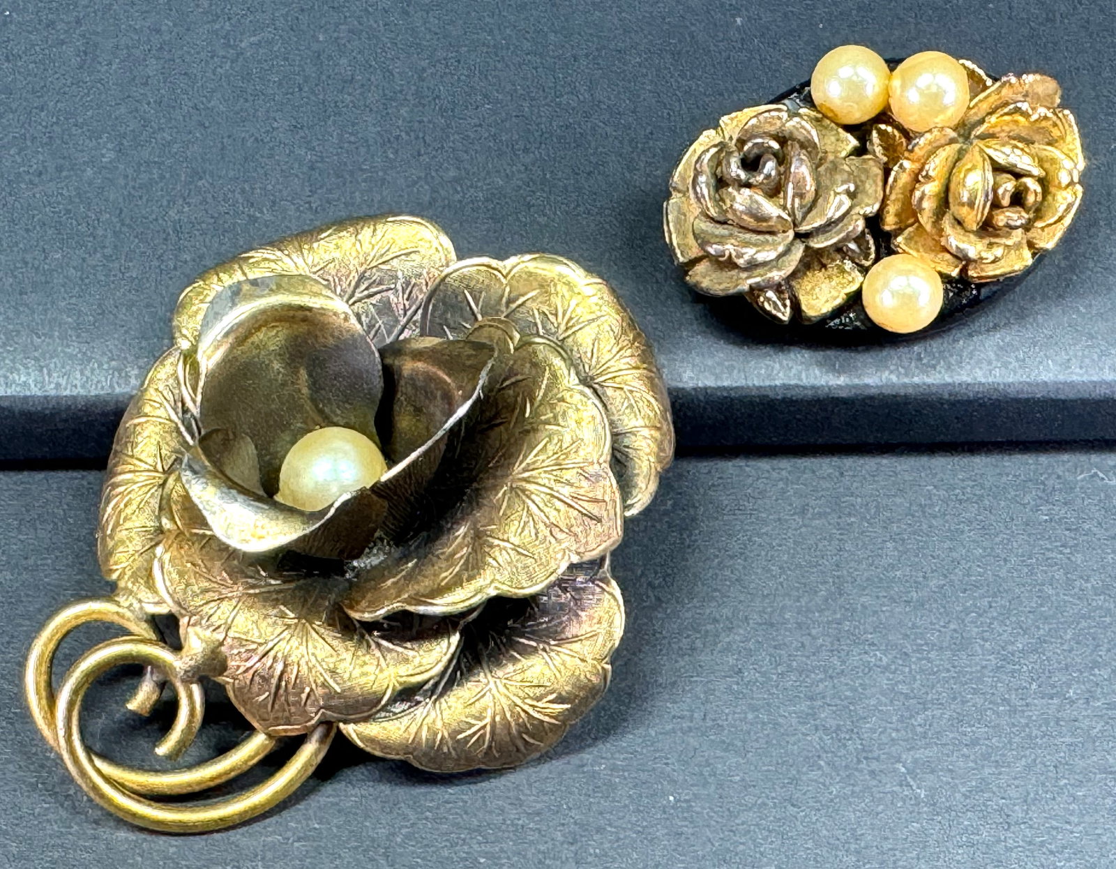 Vintage faux pearls golden metal flower & golden celluloid rose on black lucite pin brooches.: Vintage faux pearls golden metal flower & golden celluloid roses black lucite pin brooches. Unmarked. For measures please refer to the pictures taken with a measuring tape. Weight: 26 Grams. This is a