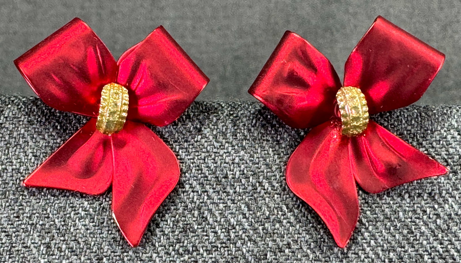 Glitter golden and metallic red ribbons in bow stud earrings: Glitter golden and metallic red ribbons in bow stud earrings. Unmarked. For measures please refer to the pictures taken with a measuring tape. Weight: 7 Grams. IN HOUSE Estimated* SHIPPING & HANDLING