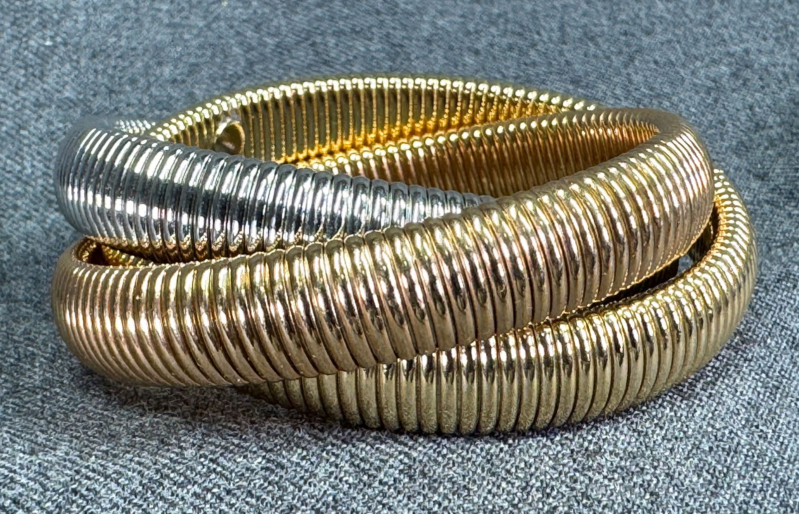 Vintage three toned omega infinity bangles bracelet: Vintage three toned omega infinity bangles bracelet. Unmarked. For measures please refer to the pictures taken with a measuring tape. Weight: 65 Grams. IN HOUSE Estimated* SHIPPING & HANDLING COST WIT