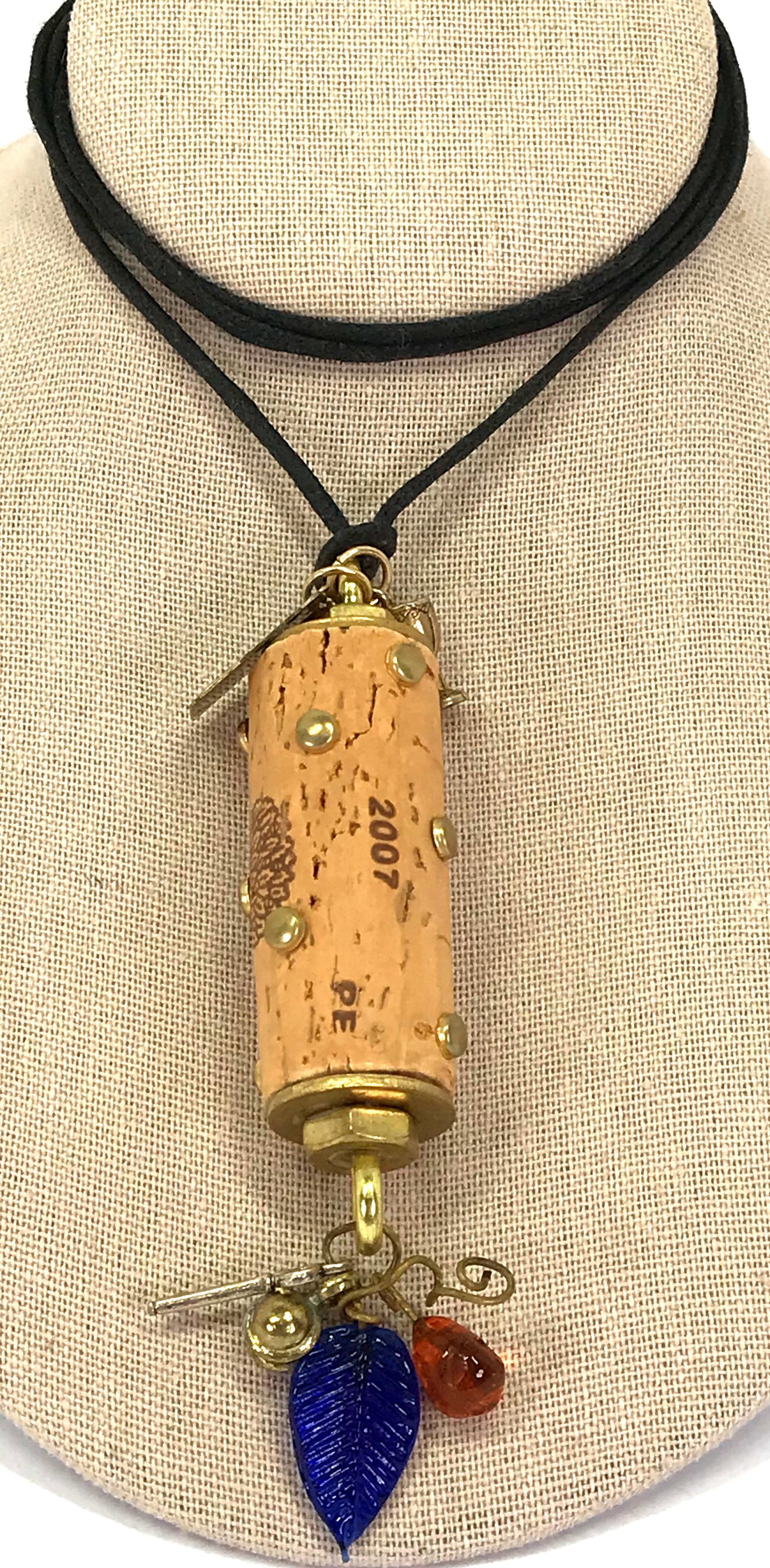 Vintage artsy assemblage wine cork Benjamin Leroux 2007 necklace: Vintage artsy assemblage wine cork Benjamin Leroux 2007 glass & metal dangles pendant black cord strap necklace. For measures please refer to the picture taken with a measuring tape. Weight: 30 Grams.