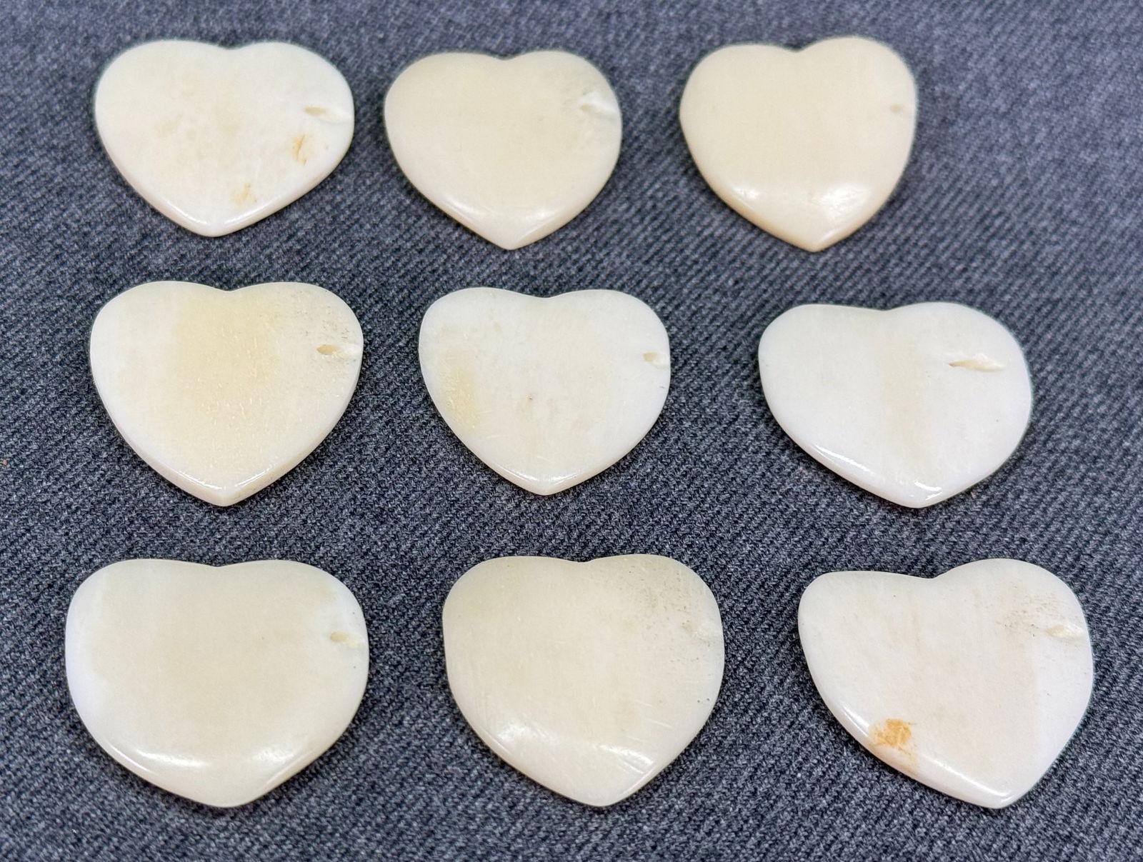 Vintage assorted bone heart beads. Lot of 9: Vintage assorted bone heart beads. Hole on side. Lot of 9. Unmarked. For measures please refer to the pictures taken with a measuring tape. Weight: 30 Grams. IN HOUSE Estimated* SHIPPING & HANDLING CO