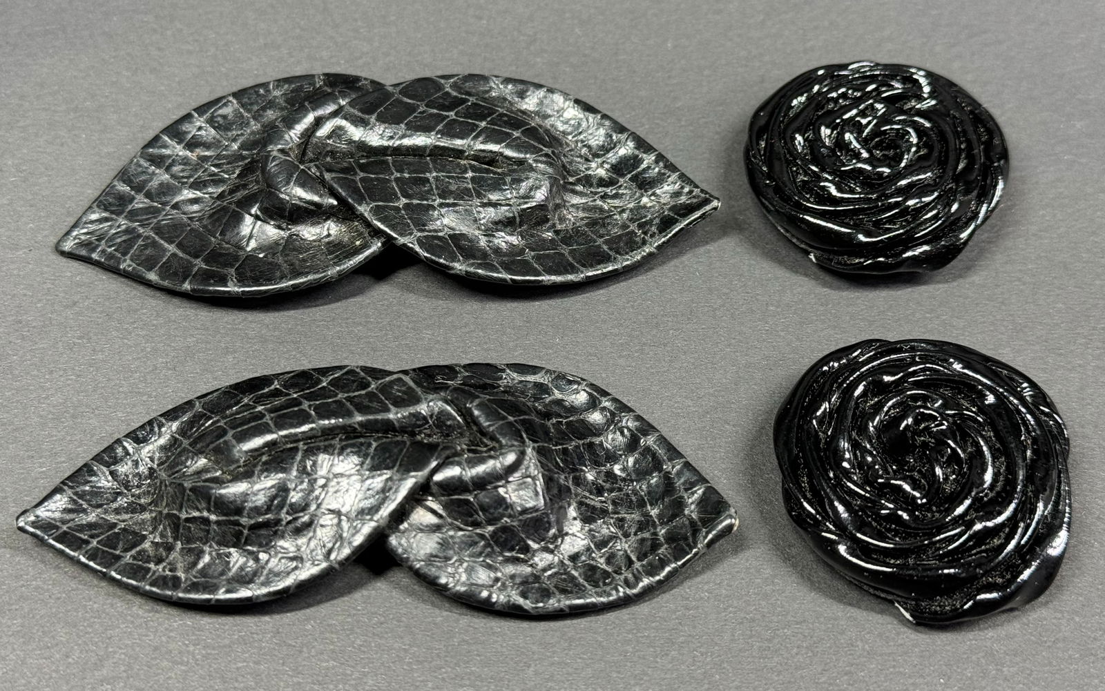 Vintage black patent leather pleated flower & textured leather bow shoe clips.: Vintage black patent leather pleated flower & textured leather bow shoe clips. Unmarked. For measures please refer to the pictures taken with a measuring tape. Weight: 18 Grams. This is a NO RESERVE A