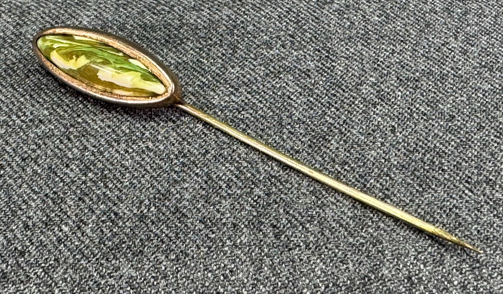 Antique marbled greenish celluloid gold-filled stick pin: Antique marbled greenish celluloid gold-filled stick pin. Unmarked. For measures please refer to the pictures taken with a measuring tape. Weight: 2 Grams. IN HOUSE Estimated* SHIPPING & HANDLING COST