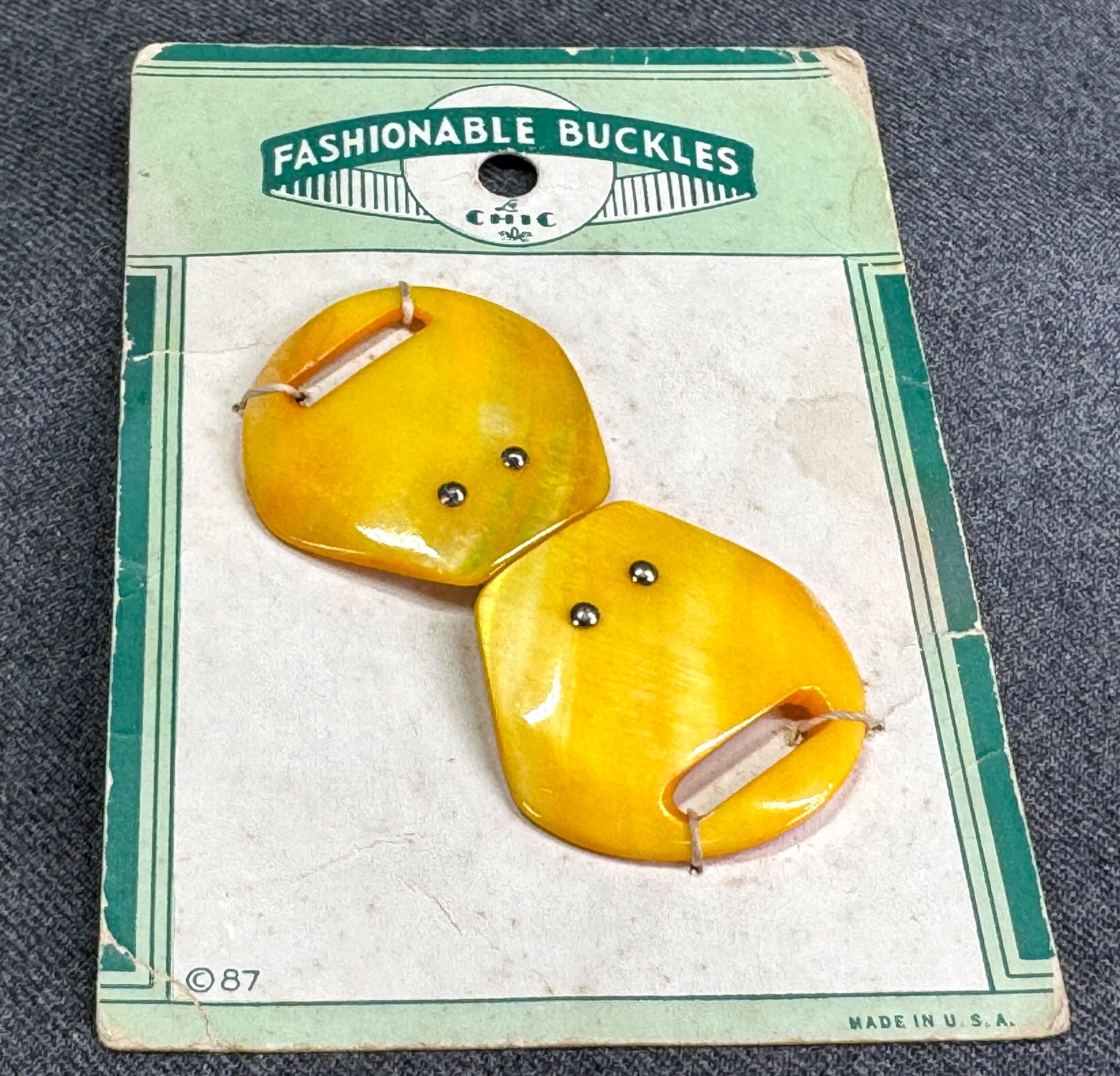 Vintage art deco dyed yellow mother of pearl belt buckle. Unused in card: Vintage art deco dyed yellow mother of pearl belt buckle. Unused in card. For measures please refer to the pictures taken with a measuring tape. Weight: 12 Grams IN HOUSE Estimated* shipping and handl