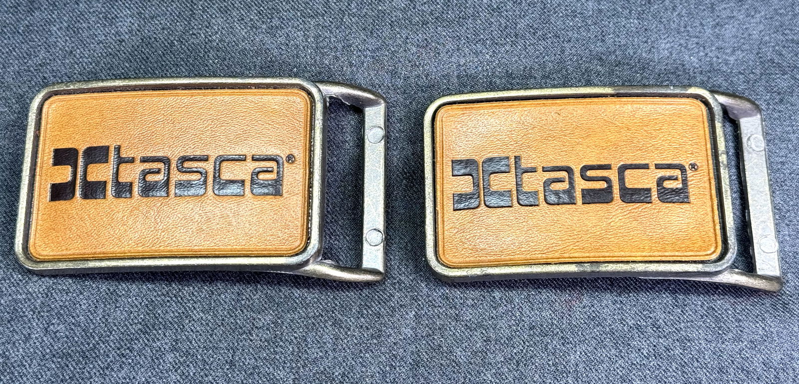 Vintage printed plastic TASCA golden metal belt buckles. Lot of 2: Vintage printed plastic TASCA golden metal belt buckles. Lot of 2. For measures please refer to the pictures taken with a measuring tape. Weight: 120 Grams . IN HOUSE Estimated* shipping and handling