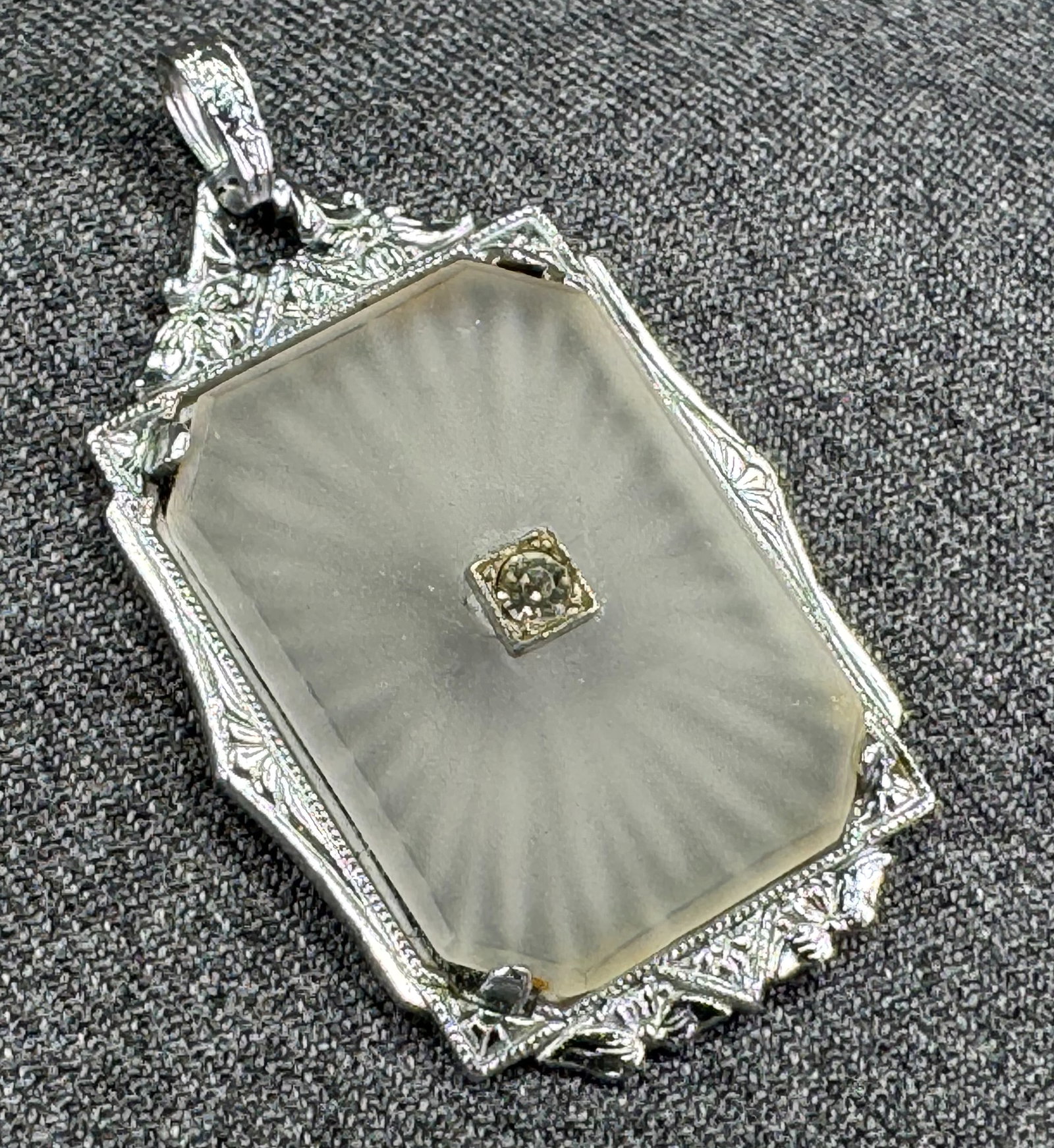 Antique art deco diamond, camphor glass silvertoned pendant: Antique art deco diamond, camphor glass silvertoned pendant. Unmarked . For measures please refer to the pictures taken with a measuring tape. Weight: 10.31 Grams. IN HOUSE Estimated* SHIPPING & HANDL