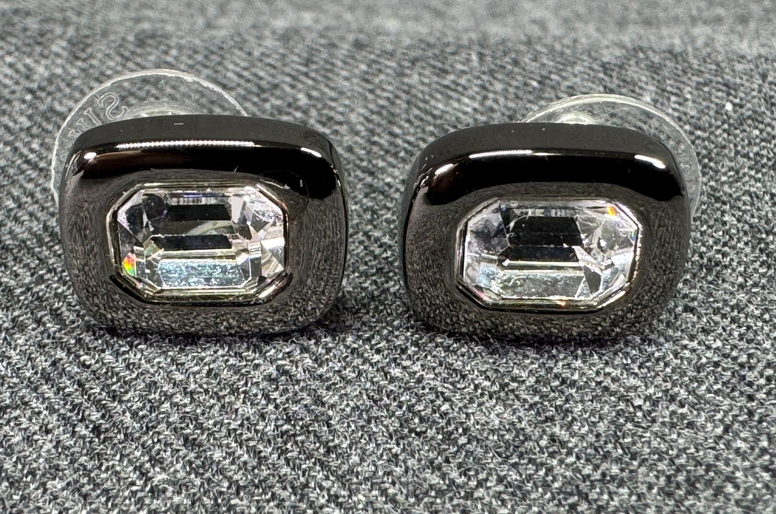 Vintage Swarovski clear crystal gunmetal stud earrings. Swan mark, pushbacks marked: Vintage Swarovski clear crystal gunmetal stud earrings. Swan mark, pushbacks marked. For measures please refer to the pictures taken with a measuring tape. Weight: 8 Grams. IN HOUSE Estimated* SHIPPIN