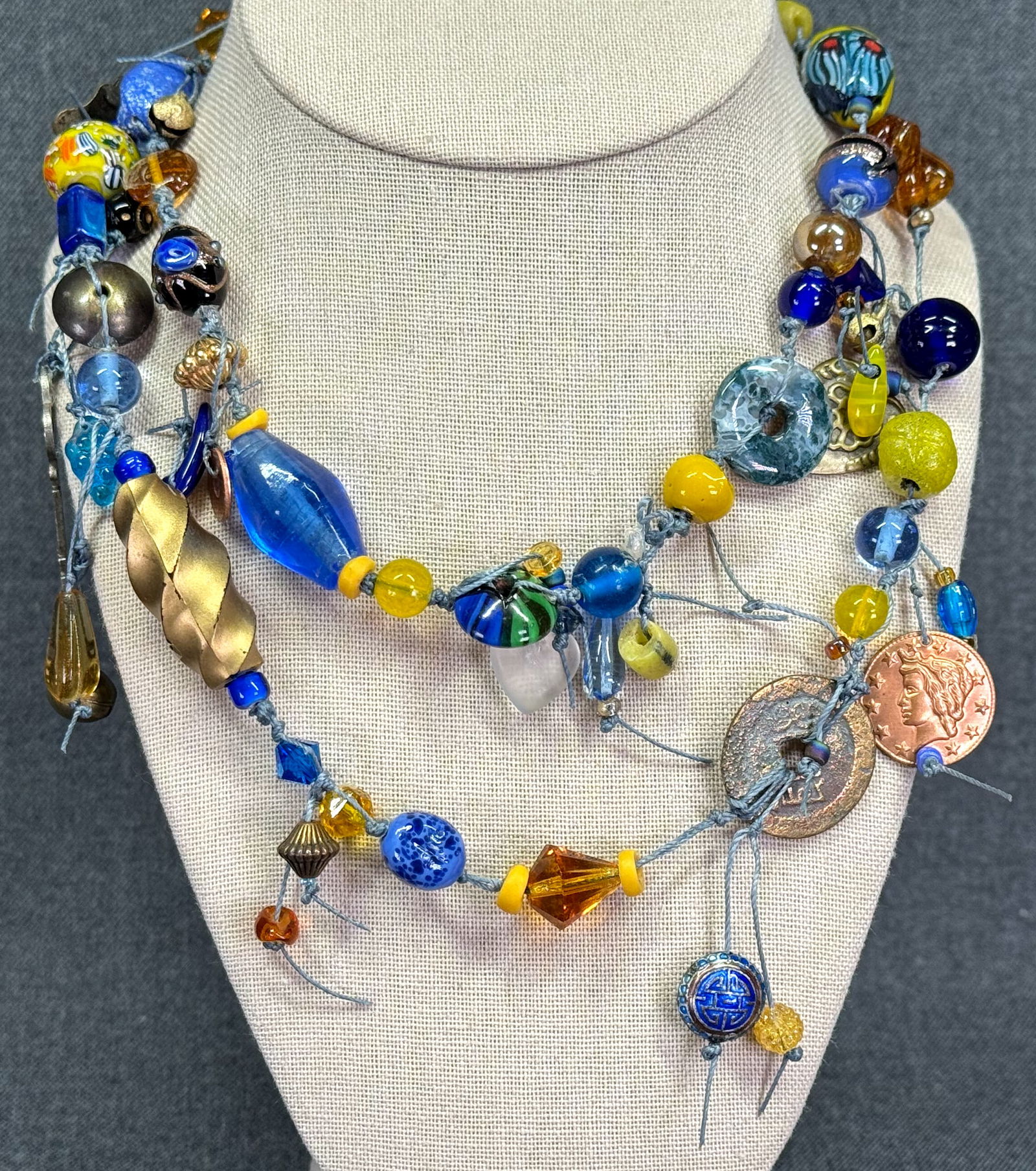 Vintage ethnic style assorted amulets charms dangles hand knotted glass beads necklace: Vintage ethnic style assorted amulets charms dangles hand knotted glass beads necklace. No clasp. Unmarked. For measures please refer to the pictures taken with a measuring tape. Weight: 120 Grams. IN