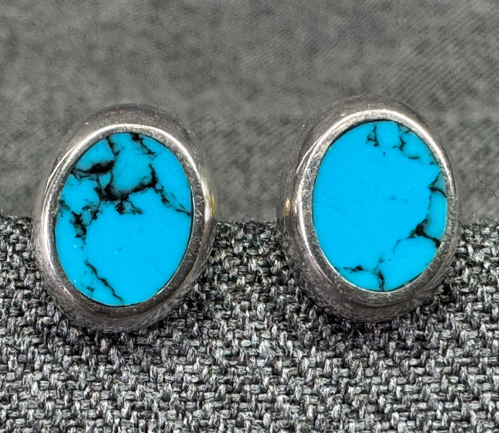 Reconstituted turquoise sterling silver stud earrings: Reconstituted turquoise sterling silver stud earrings. Marked 925. For measures please refer to the pictures taken with a measuring tape. Weight: 2.23 Grams. IN HOUSE Estimated* SHIPPING & HANDLING CO