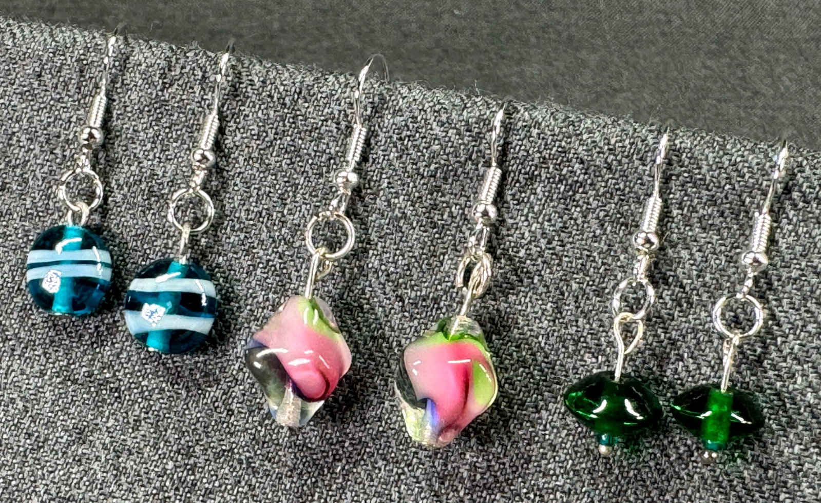 Unused assorted color glass silvertoned hook earrings.: Unused assorted color glass silvertoned hook earrings.. Unmarked. For measures please refer to the pictures taken with a measuring tape. Weight: 9 Grams IN HOUSE Estimated* SHIPPING & HANDLING COST WI
