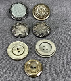 Vintage assorted grayish galalith buttons. Lot of 7