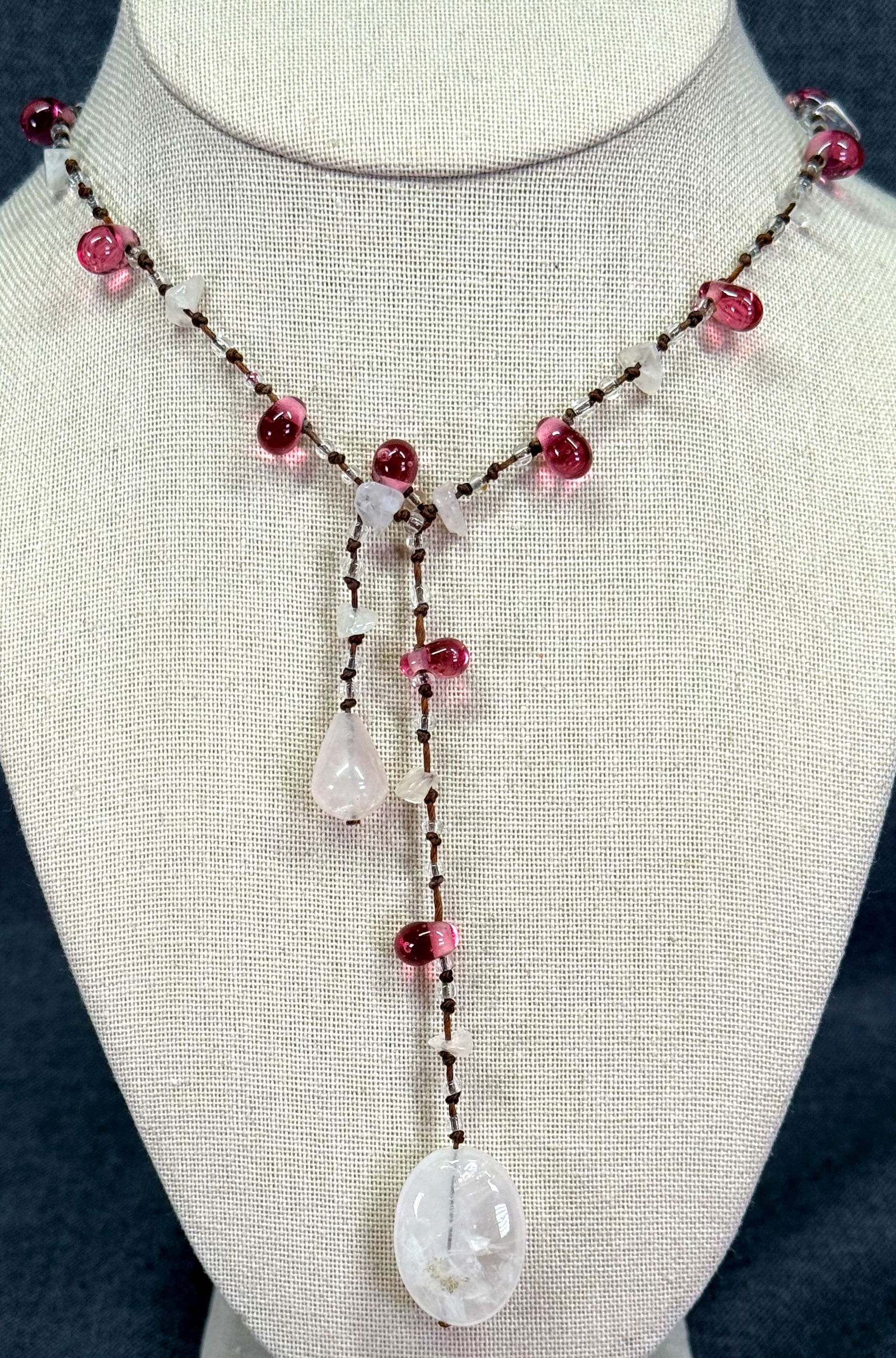 Rose quartz and rose glass hand knotted beaded lariat strap necklace: Rose quartz and rose glass hand knotted beaded lariat strap necklace. Unmarked. For measures please refer to the pictures taken with a measuring tape. Weight: 20 Grams. IN HOUSE Estimated* SHIPPING &