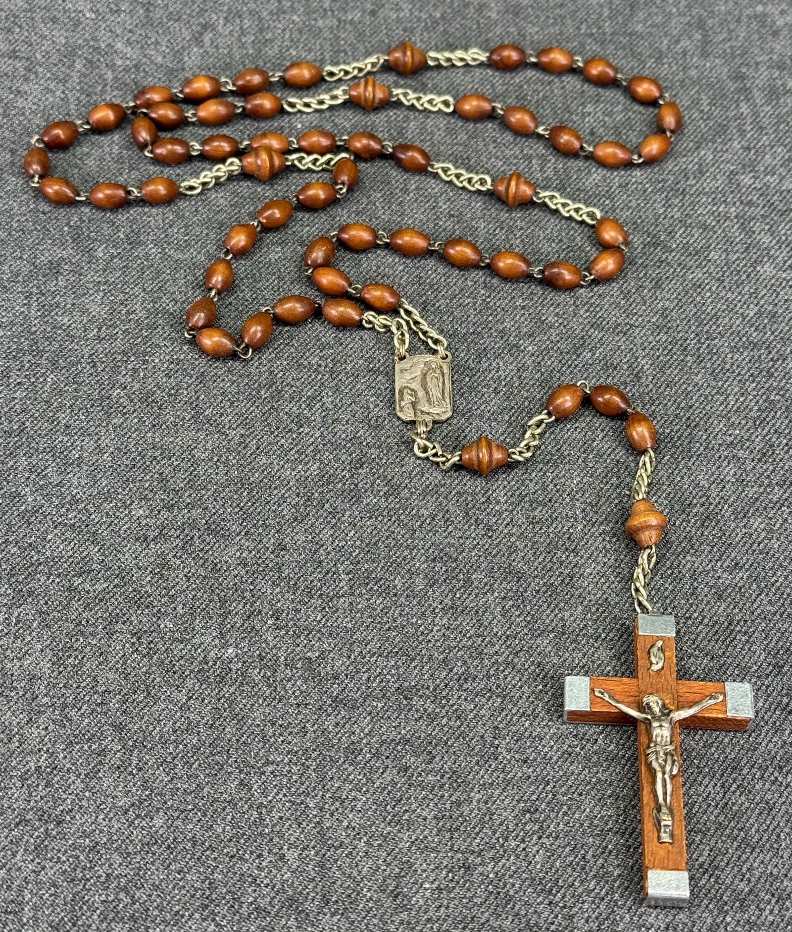 Vintage French Lourdes olive wood beads silvertoned metal rosary: Vintage French Lourdes olive wood beads silvertoned metal rosary. Marked Lourdes and France. For measures please refer to the pictures taken with a measuring tape. Weight: 14 Grams. IN HOUSE Estimated
