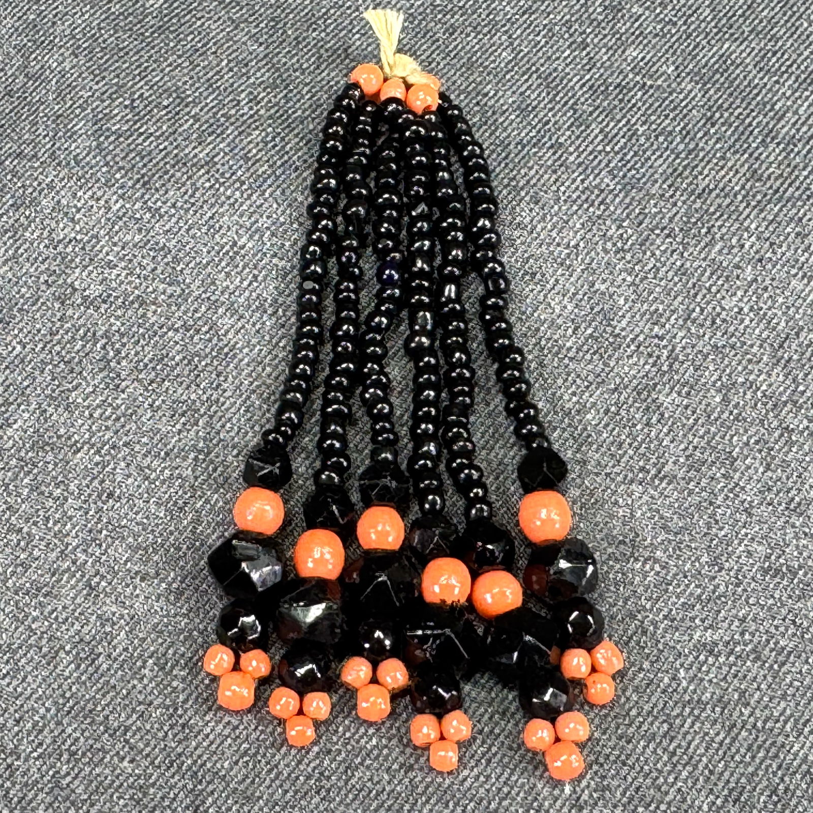 Antique Edwardian / Art deco black & coral color glass beads tassel #1: Antique Edwardian / Art deco black & coral color glass beads tassel. For measures please refer to the pictures taken with a measuring tape. IN HOUSE Estimated* shipping and handling cost within the U.