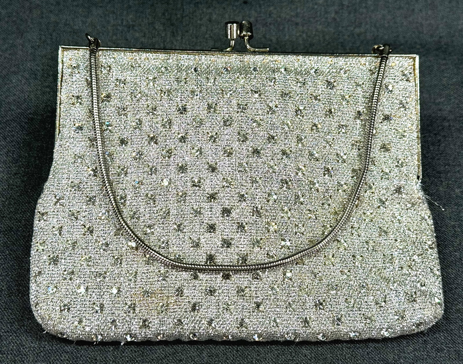 Vintage encrusted with prongs clear rhinestones silvertone metallic fabric purse bag.: Vintage encrusted with prongs clear rhinestones silvertone metallic fabric purse bag. Silvertone metal frame and chain strap. The interior is lined with fabric . For measures please refer to the pictu
