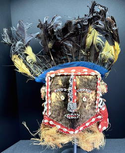 African Bushoong People (Kuba Kingdom) DRC Moshanbwooy Helmet Mask.: African Bushoong People (Kuba Kingdom) DRC Moshanbwooy Helmet Mask. Raffia, cloth, fiber, glass beads, cowrie shells, feathers, wood, fur. It measures 25 inches tall, 17 inches wide on top and 6 1/2 i